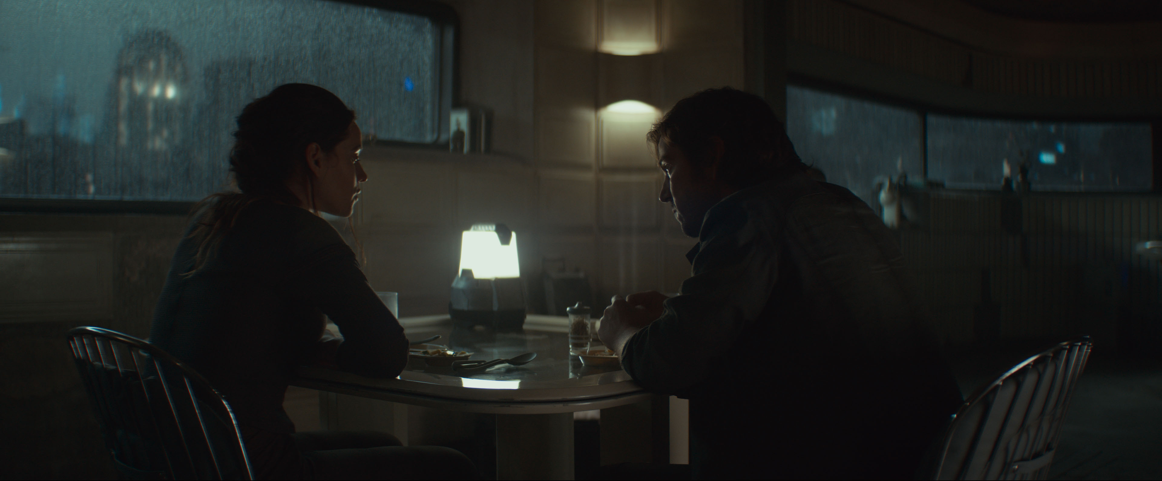 Bix and Cassian sitting at a table looking intense in Coruscant Bix and Cassian sitting at a table looking intense in Coruscant