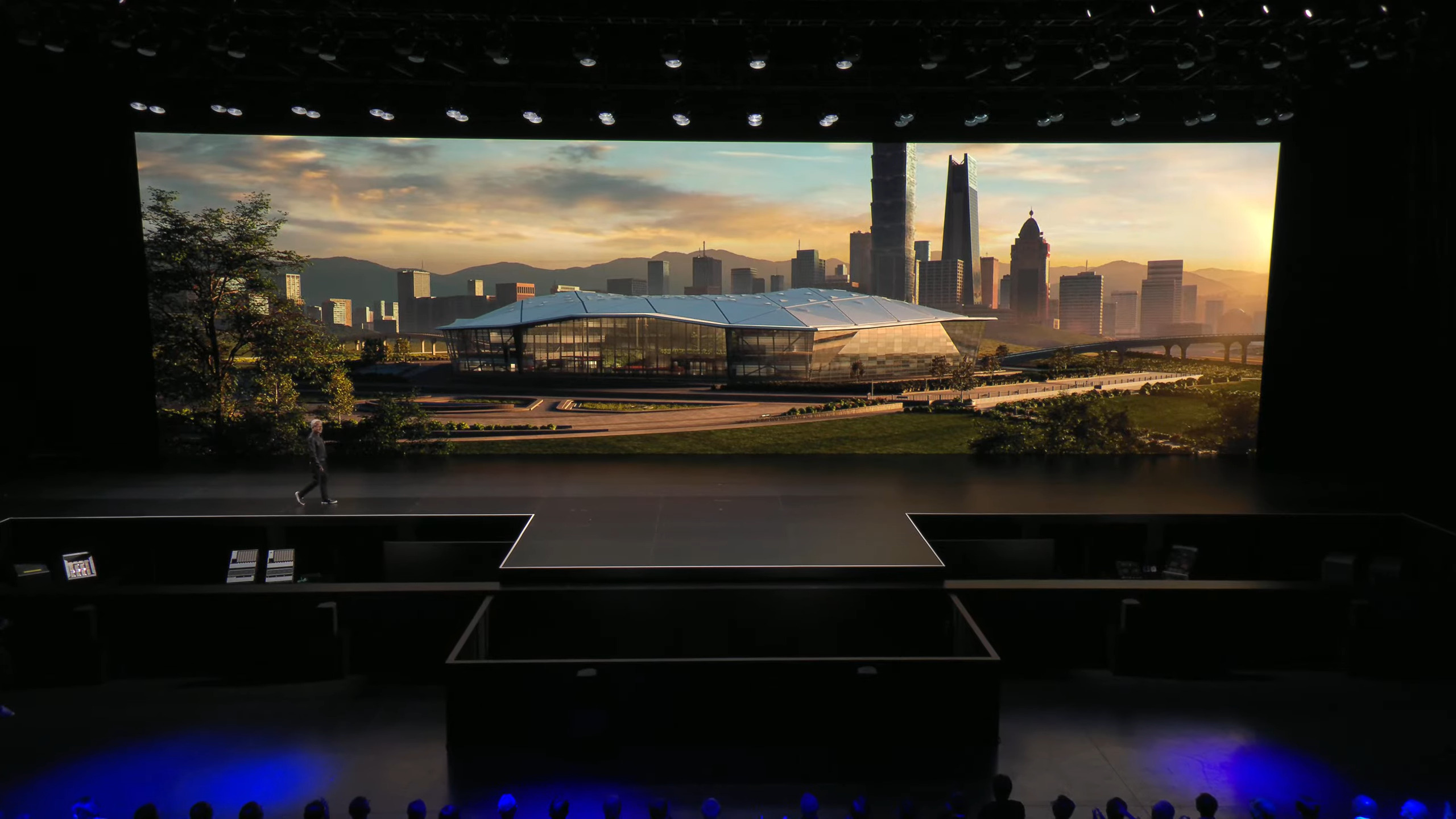 Jensen Huang walking back onto the stage as the Nvidia Constellation office is revealed behind him