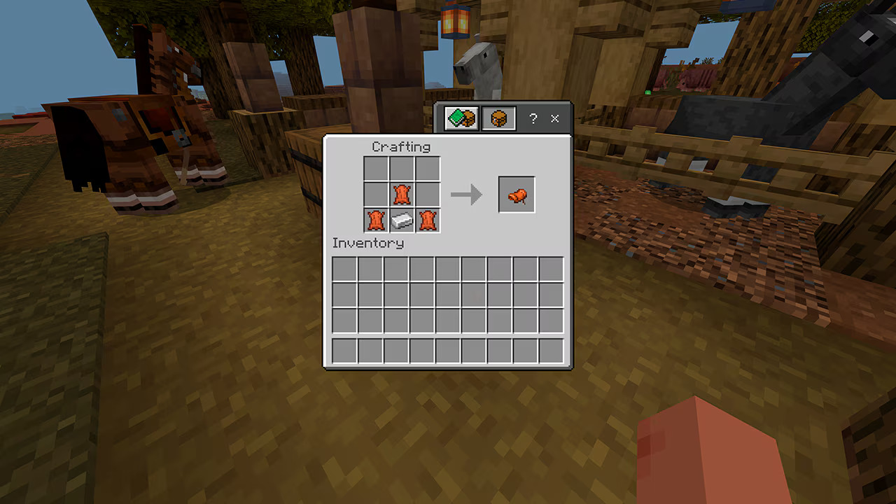 Minecraft crafting menu showing the three leather and one iron ingot recipe pattern for crafting saddles. Minecraft crafting menu showing the three leather and one iron ingot recipe pattern for crafting saddles.