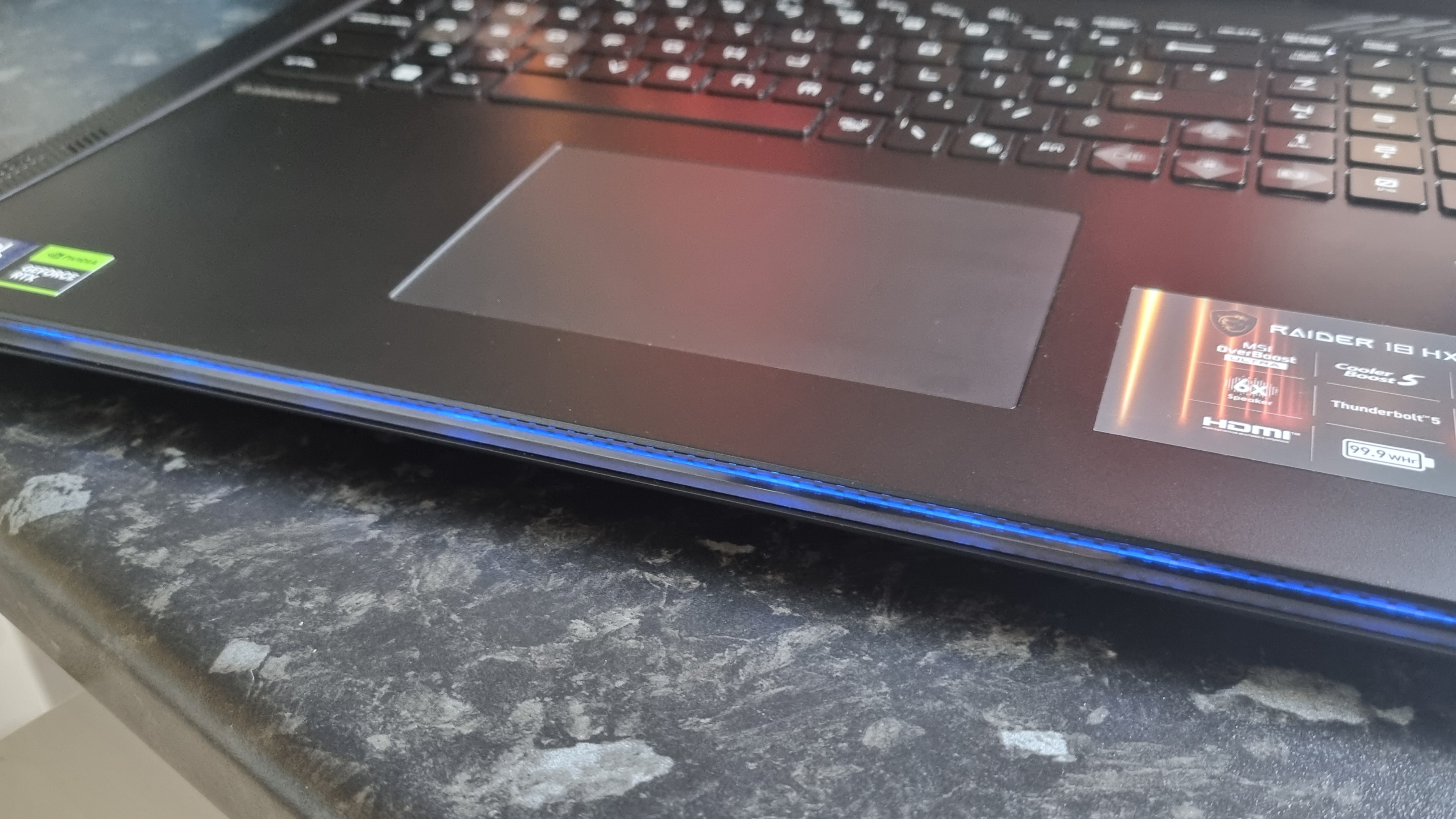 The RGB lip of the MSI Raider 18 HX AI A2XW, lit in blue
