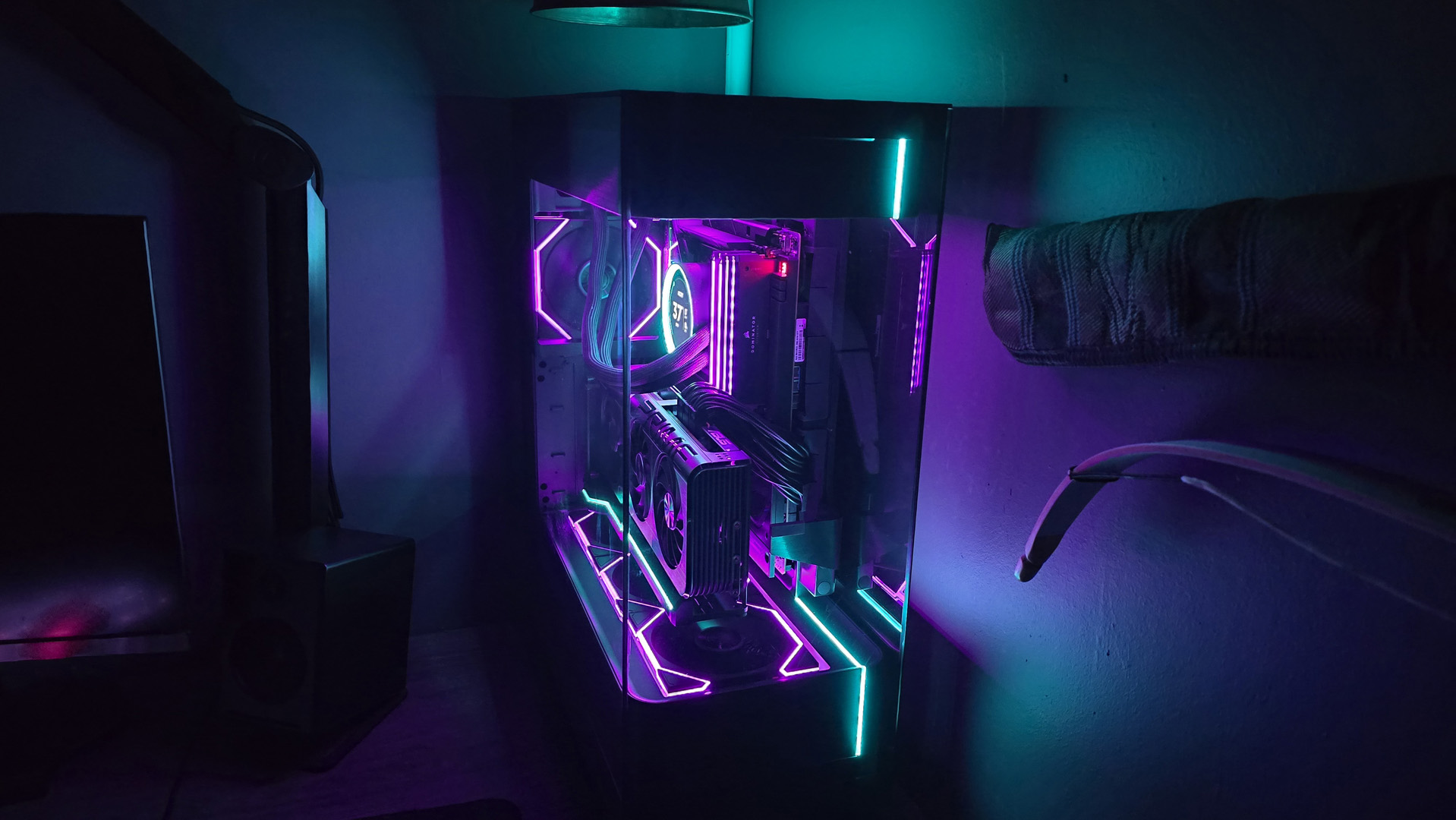 A gaming PC lit up with neon-style lighting and using an RX 9070 XT graphics card.