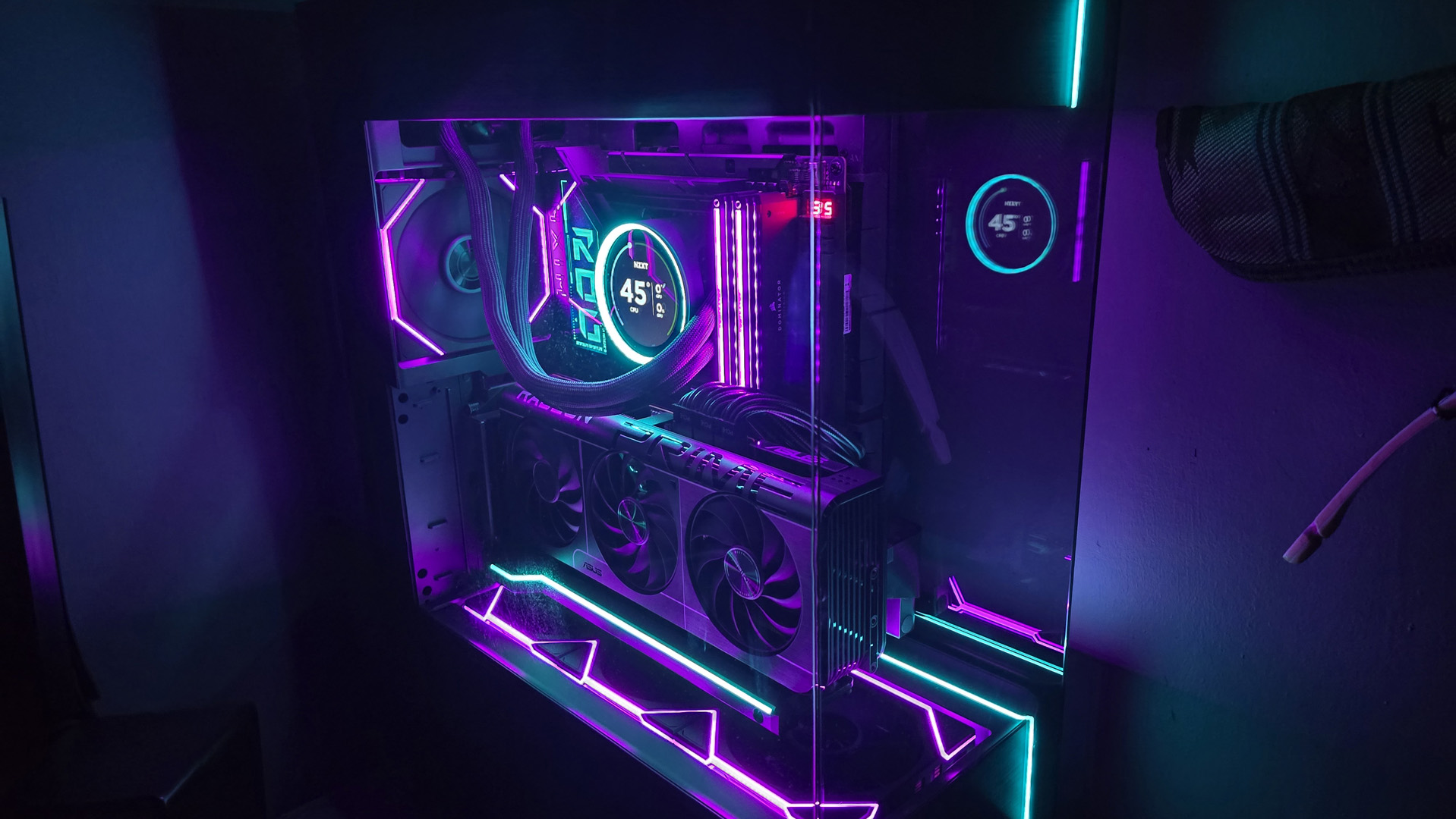 A gaming PC lit up with neon-style lighting and using an RX 9070 XT graphics card.
