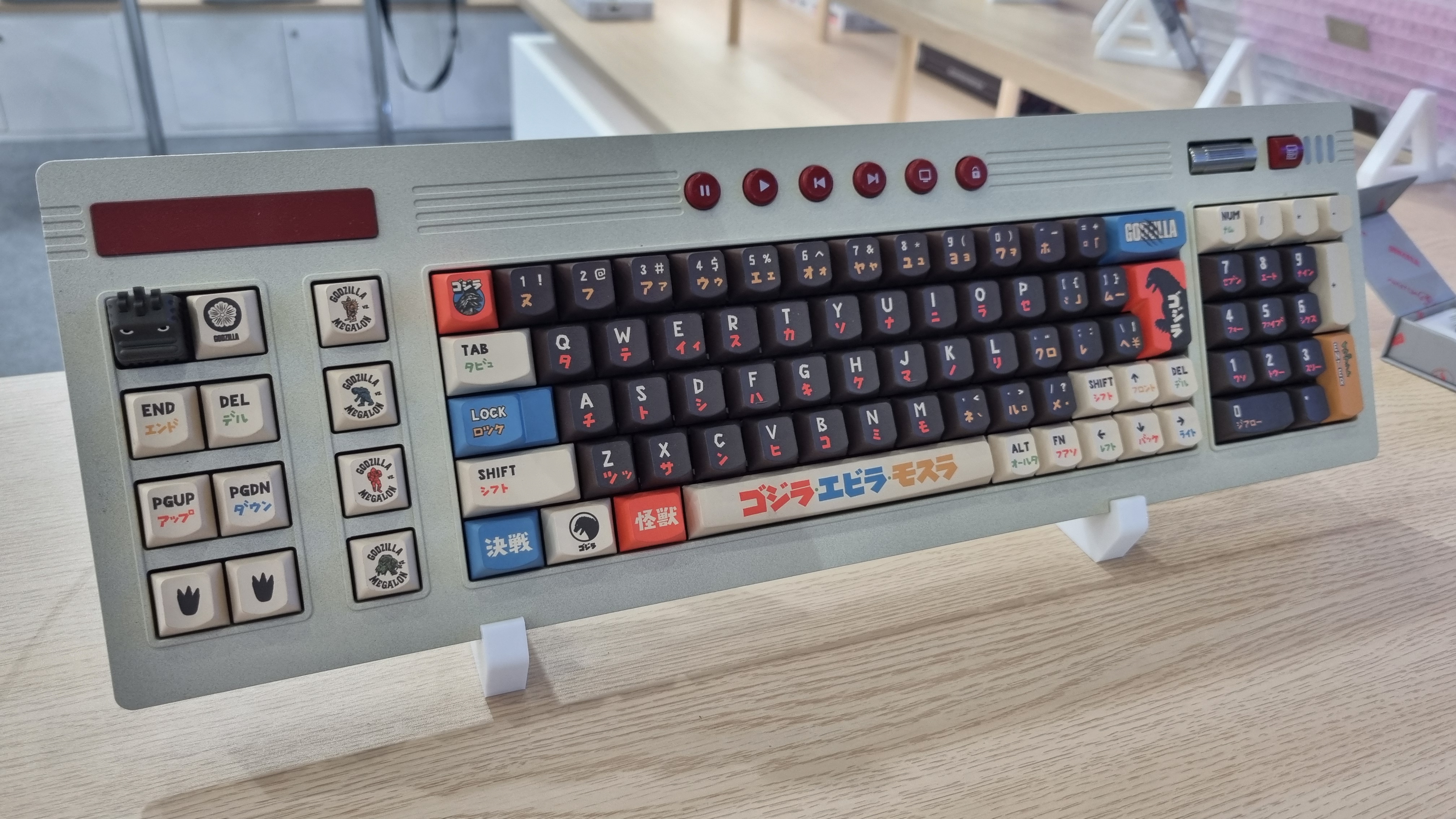 Various custom Godzilla keycaps and boxes at the KeyTok booth, 2025