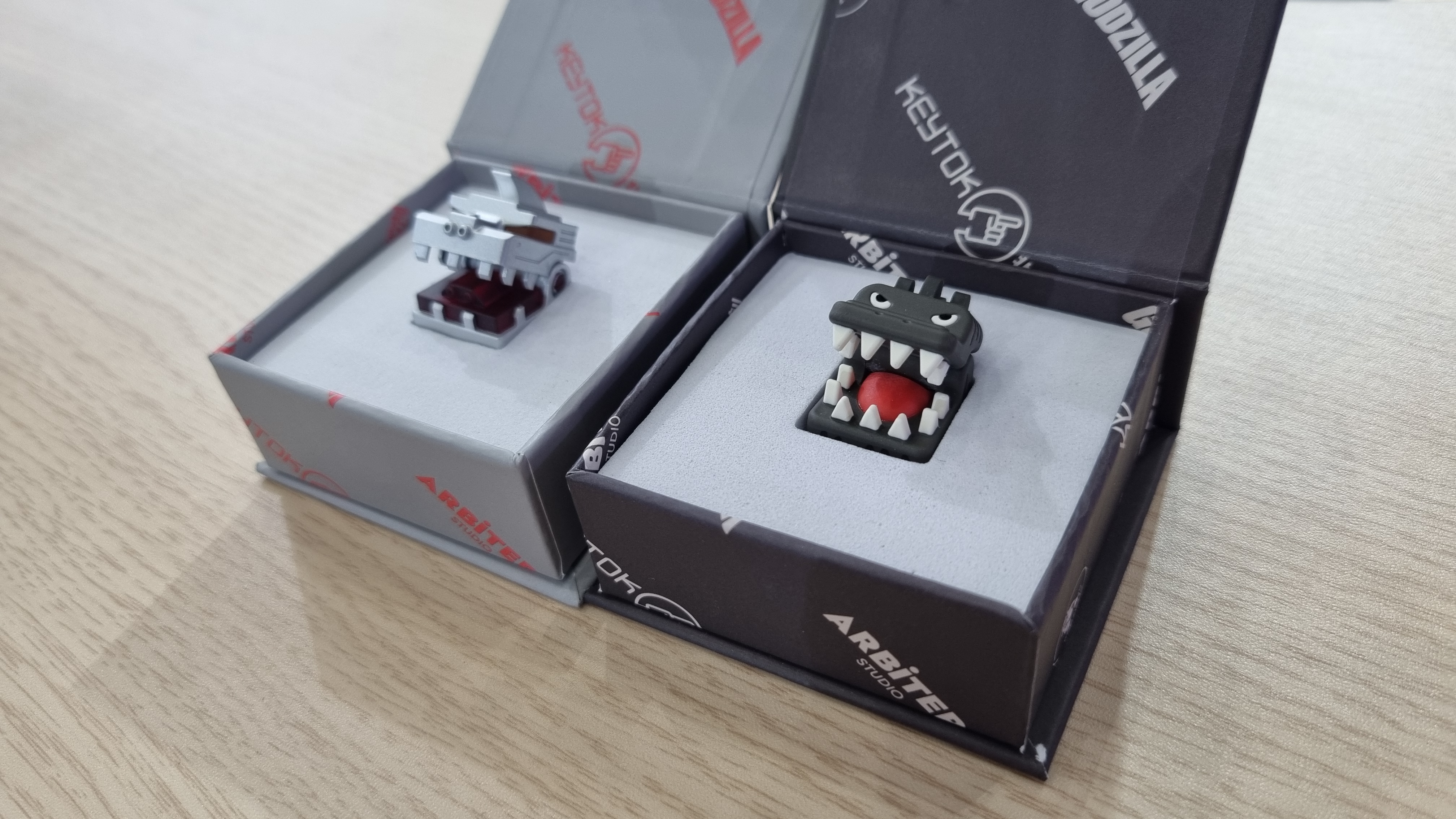 Various custom Godzilla keycaps and boxes at the KeyTok booth, 2025