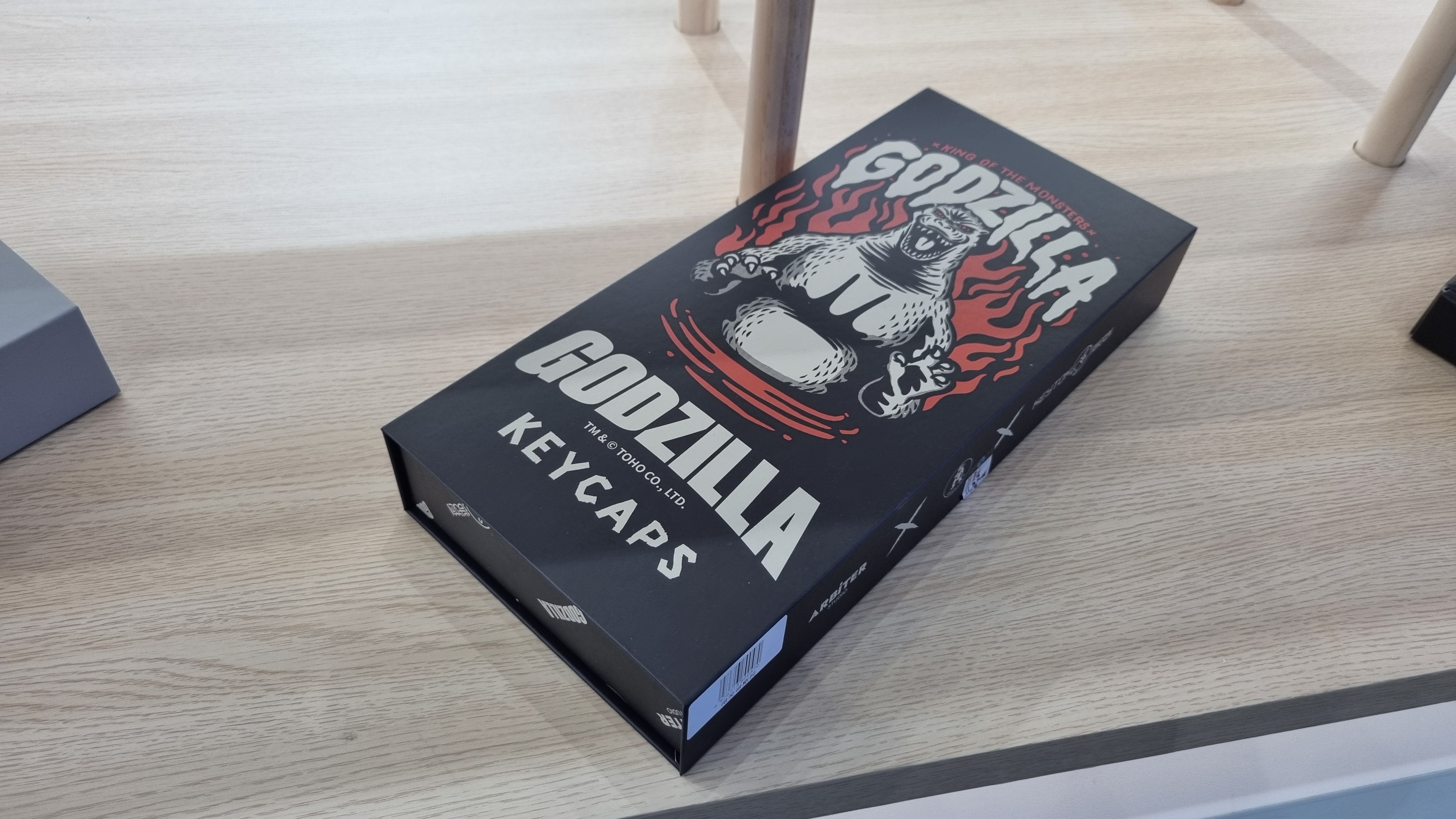 Various custom Godzilla keycaps and boxes at the KeyTok booth, 2025