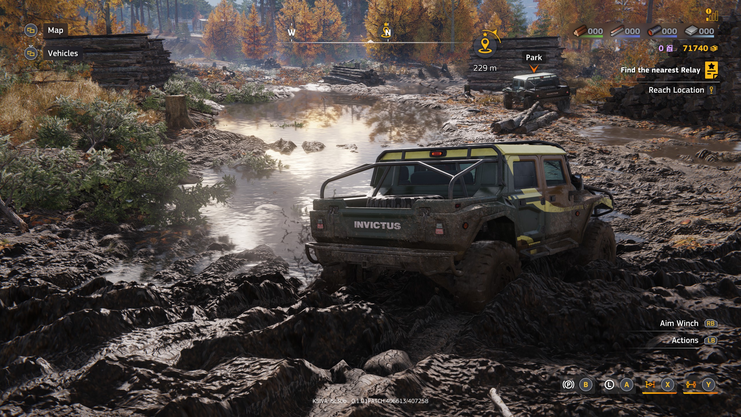 Two offroad vehicles driving through mud