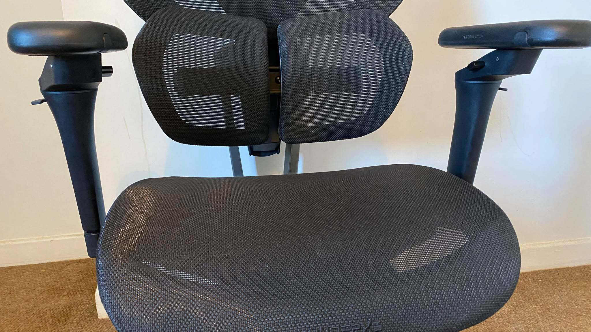 ThunderX3 chair set up in front of a white wall.