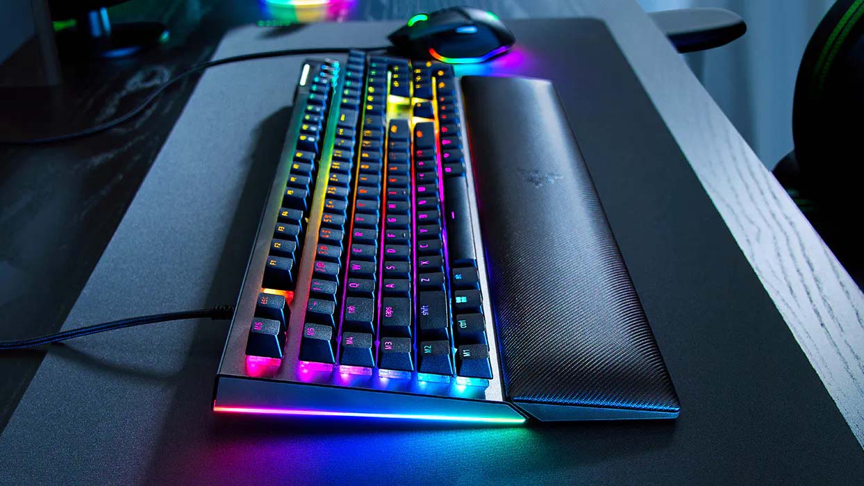 Razer gaming keyboard and mouse with RGB lighting on both, set on a desk