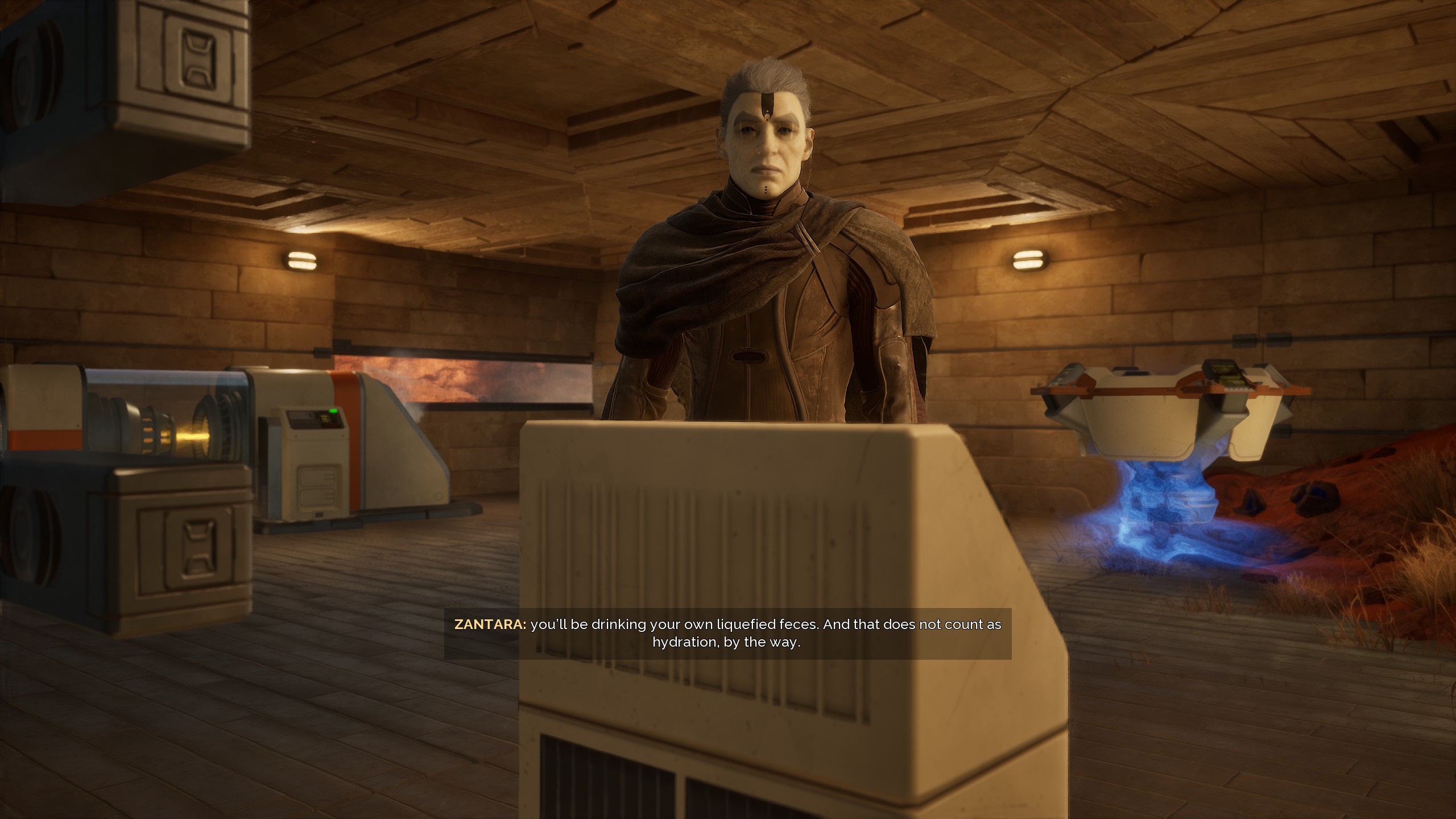 Zantara, Dune Awakening’s guide, telling the player: “You’;ll be drinking your own liquified feces. And that does not count as hydration, by the way” Zantara, Dune Awakening’s guide, telling the player: “You’;ll be drinking your own liquified feces. And that does not count as hydration, by the way”