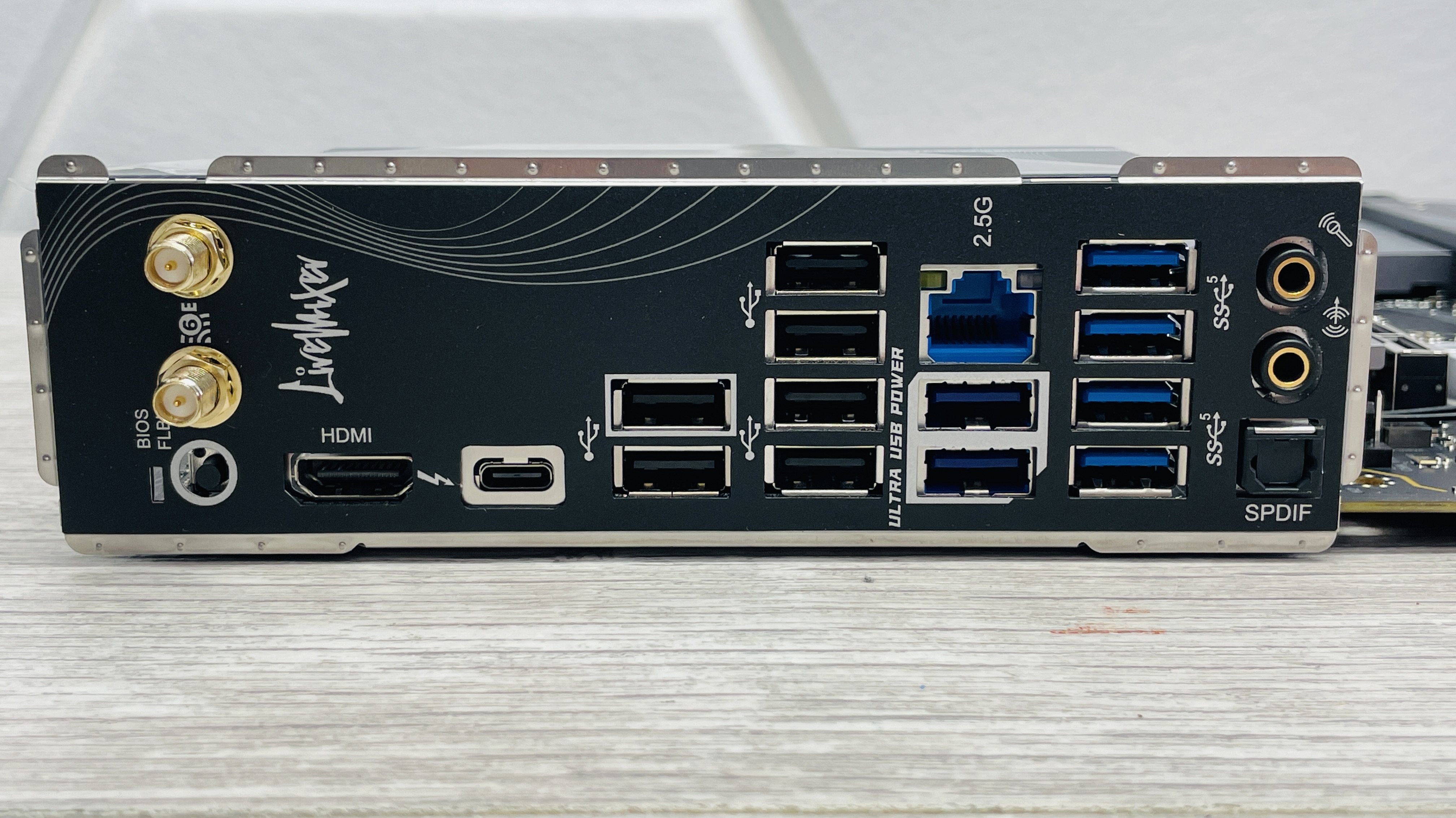 An ASRock B860 LiveMixer Wi-Fi motherboard on a desk.