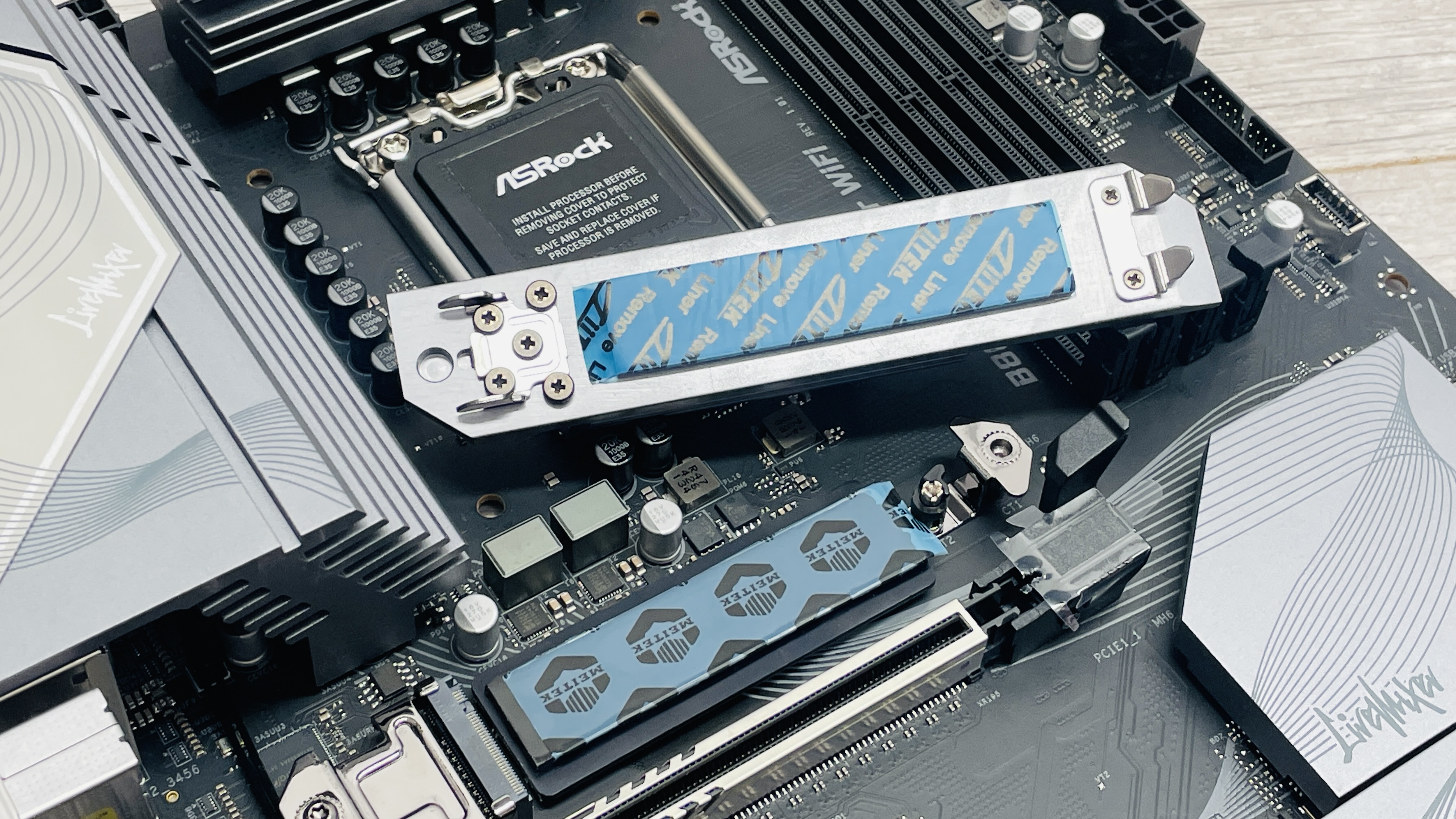 An ASRock B860 LiveMixer Wi-Fi motherboard on a desk.
