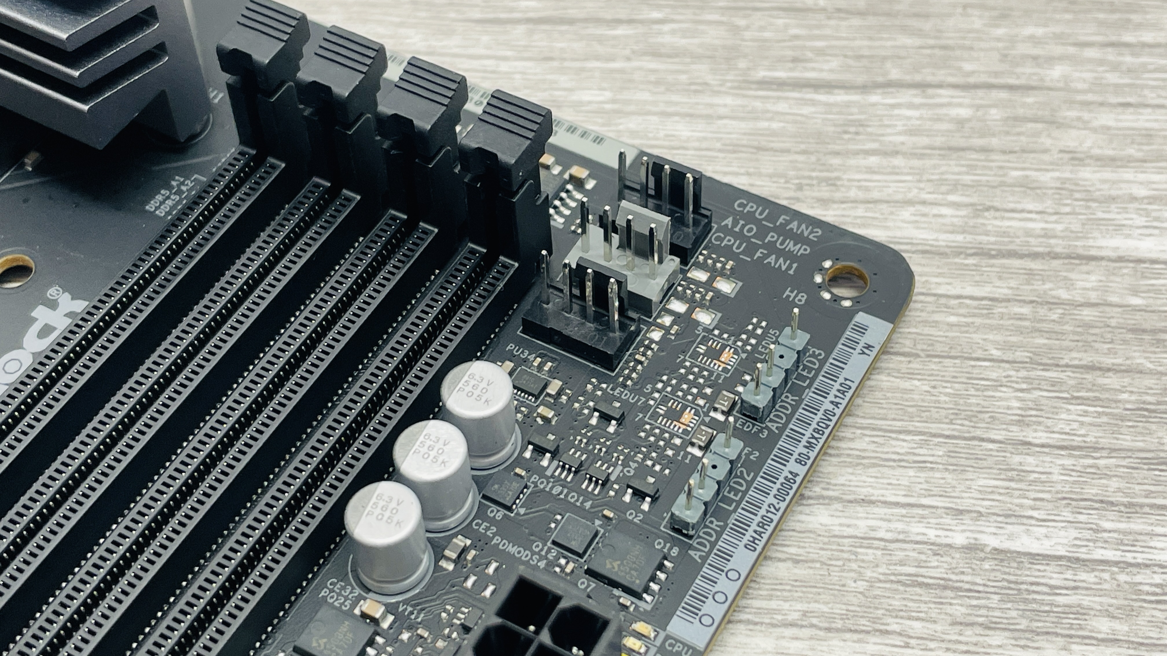 An ASRock B860 LiveMixer Wi-Fi motherboard on a desk.