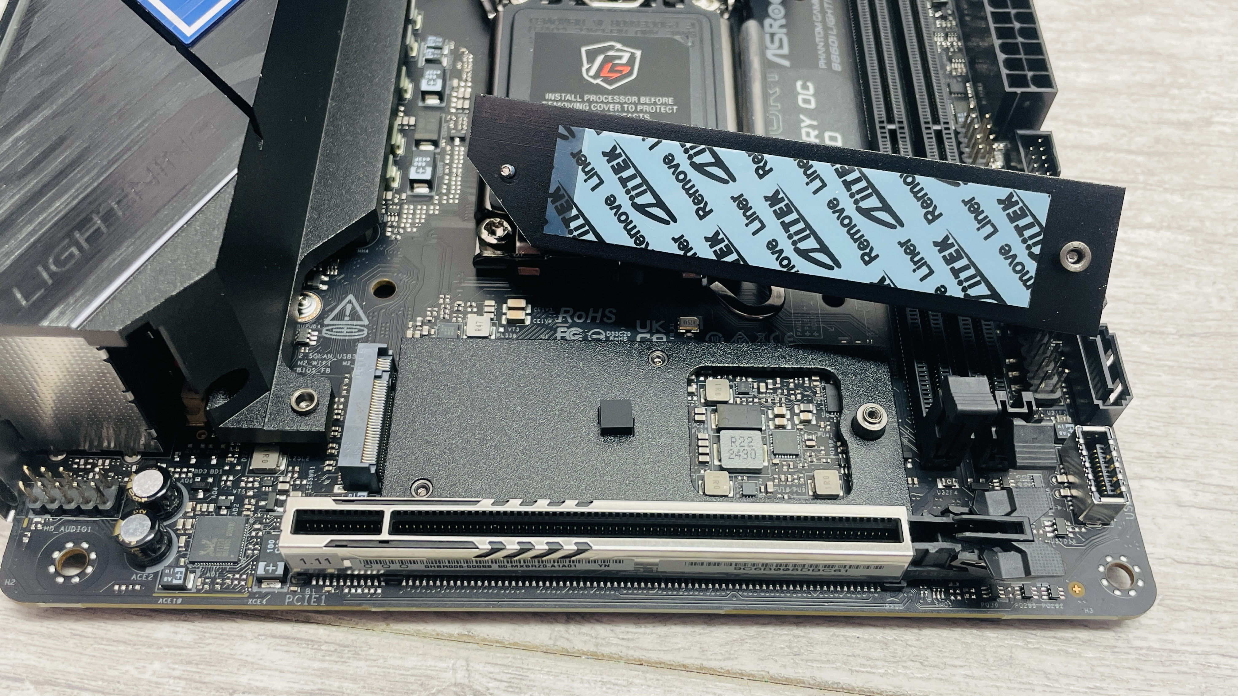 ASRock Phantom Gaming B860I Lightning Wi-Fi motherboard on a desk.