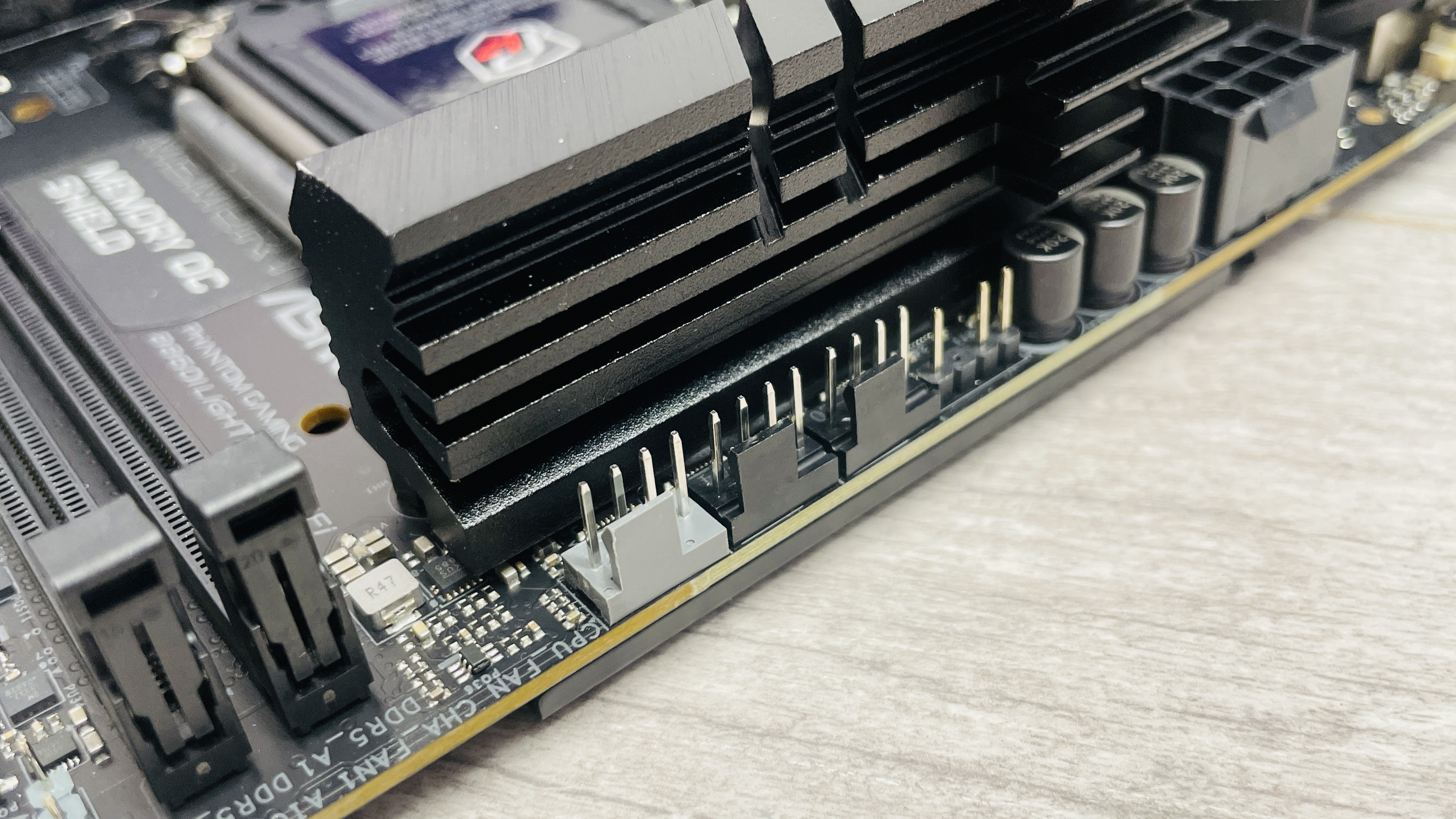 ASRock Phantom Gaming B860I Lightning Wi-Fi motherboard on a desk.