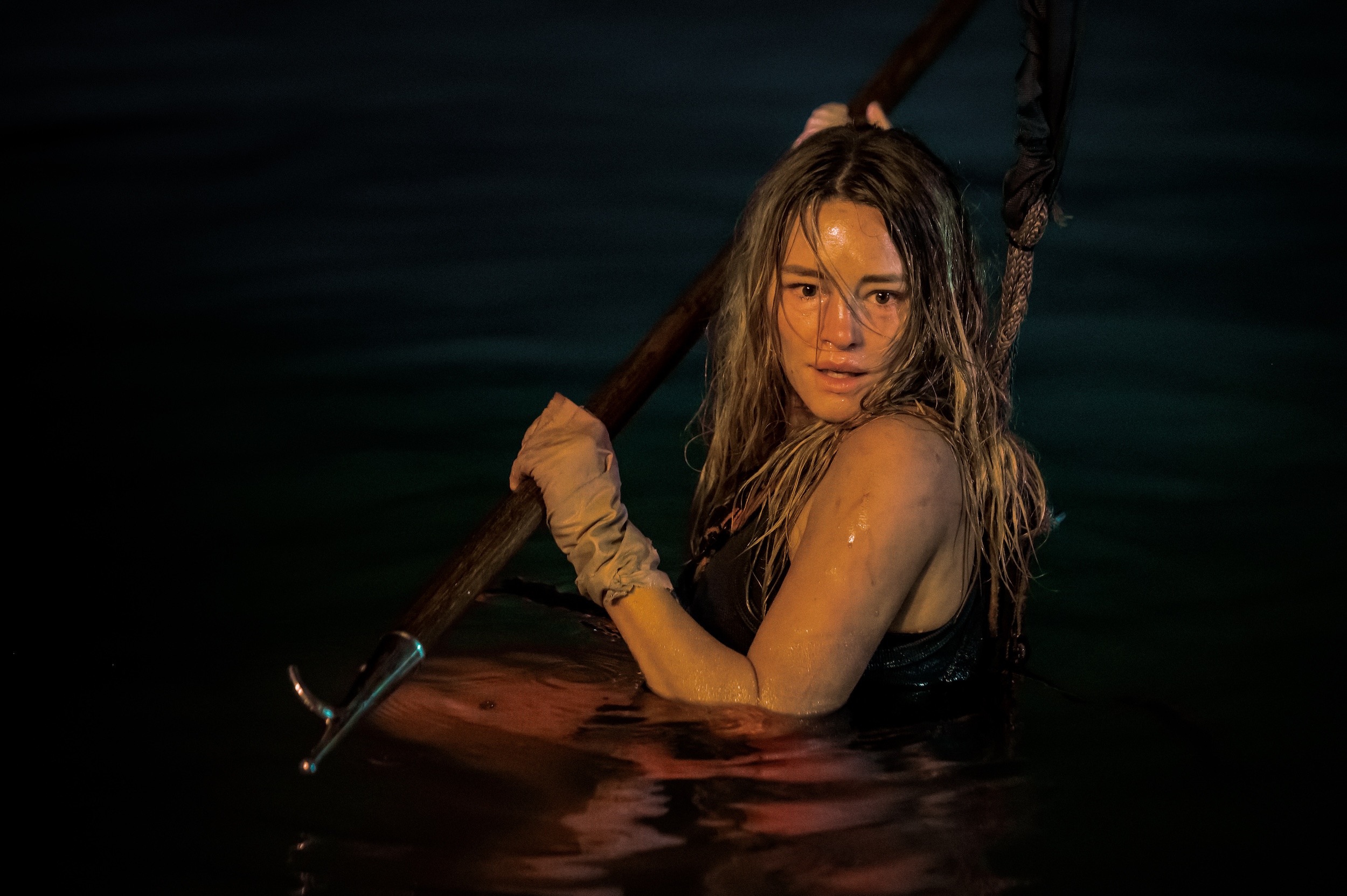 Zephyr (Hassie Harrison) holding a spear in Dangerous Animals Zephyr (Hassie Harrison) holding a spear in Dangerous Animals