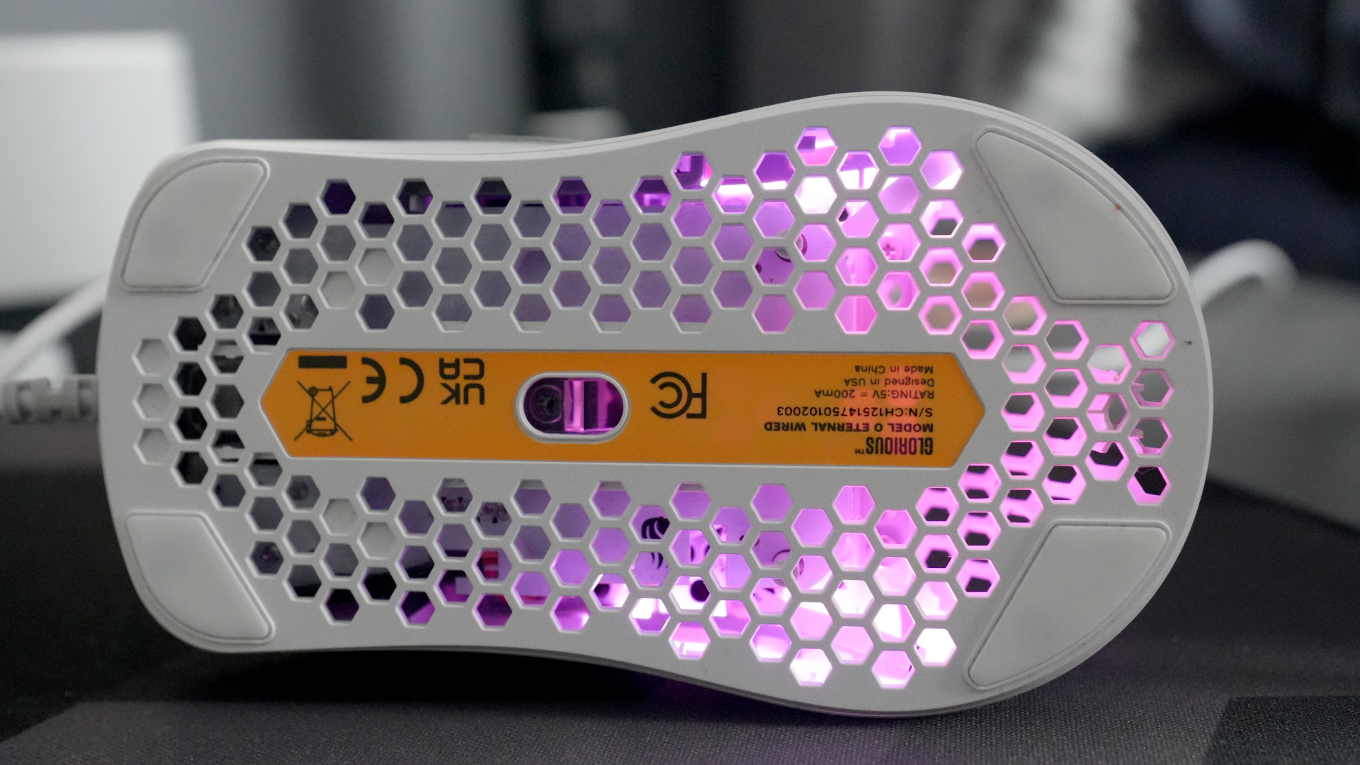 A Glorious Model O Eternal gaming mouse on a mouse mat with the lighting enabled.