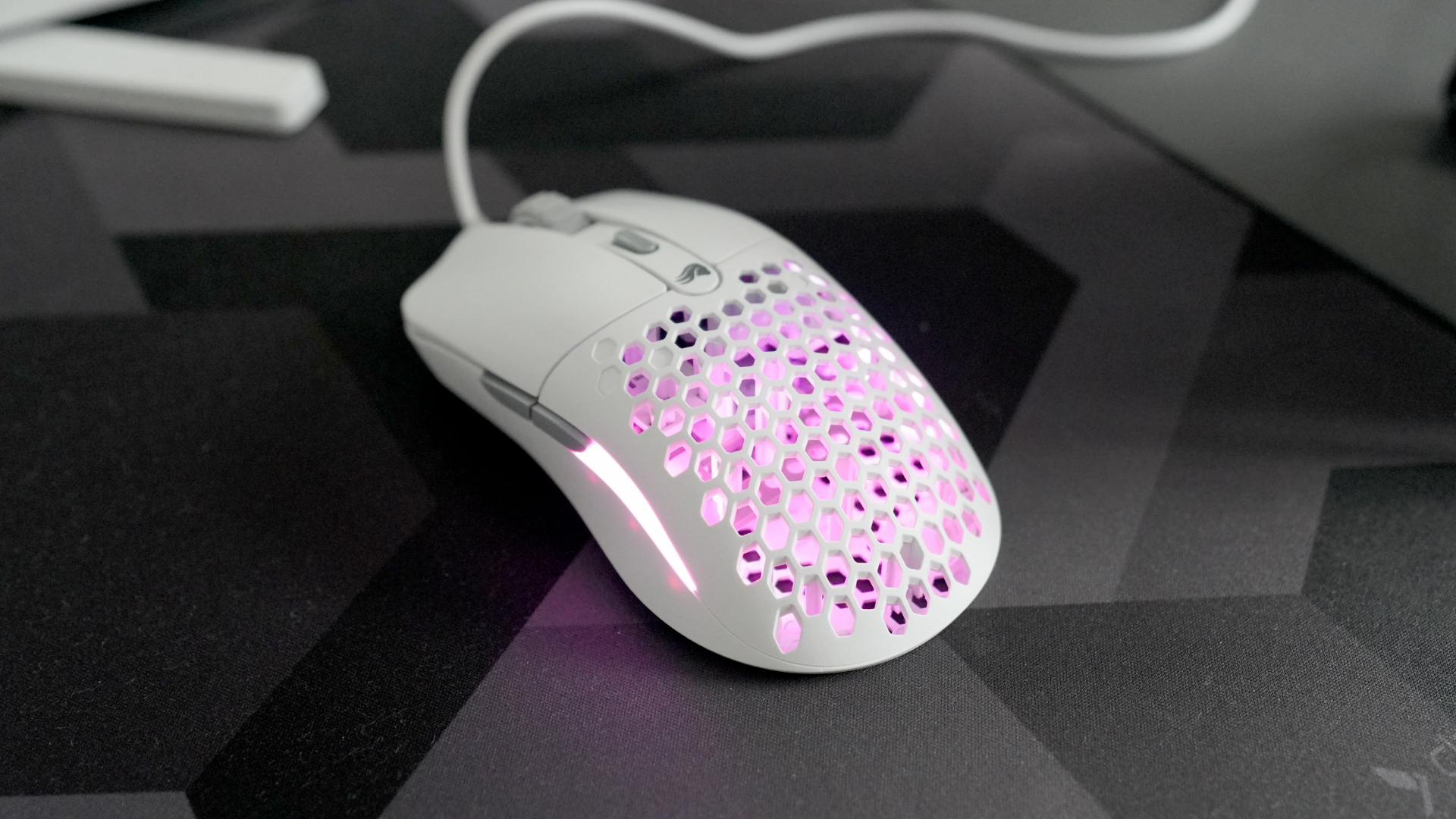 A Glorious Model O Eternal gaming mouse on a mouse mat with the lighting enabled.