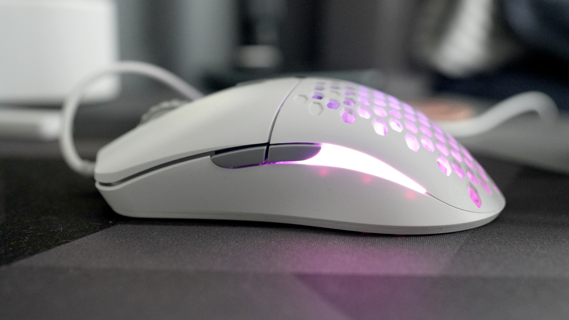 A Glorious Model O Eternal gaming mouse on a mouse mat with the lighting enabled.