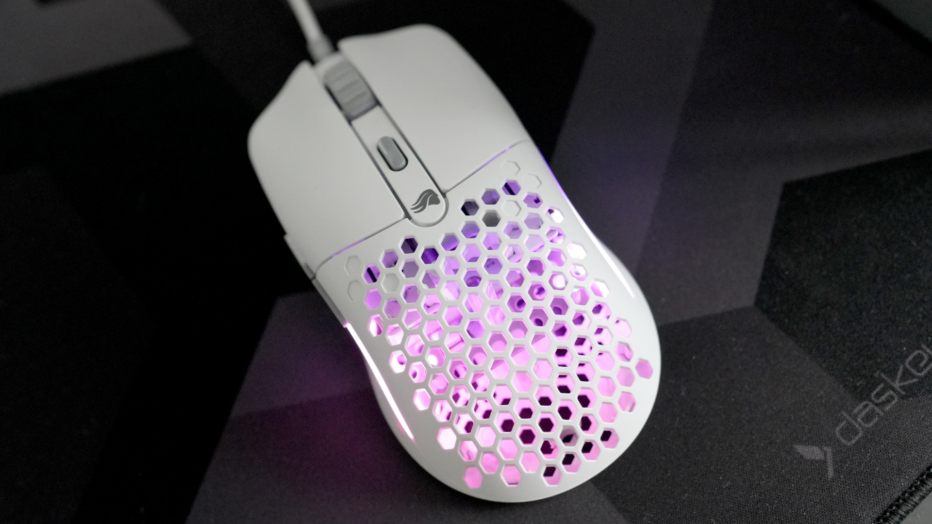 A Glorious Model O Eternal gaming mouse on a mouse mat with the lighting enabled.