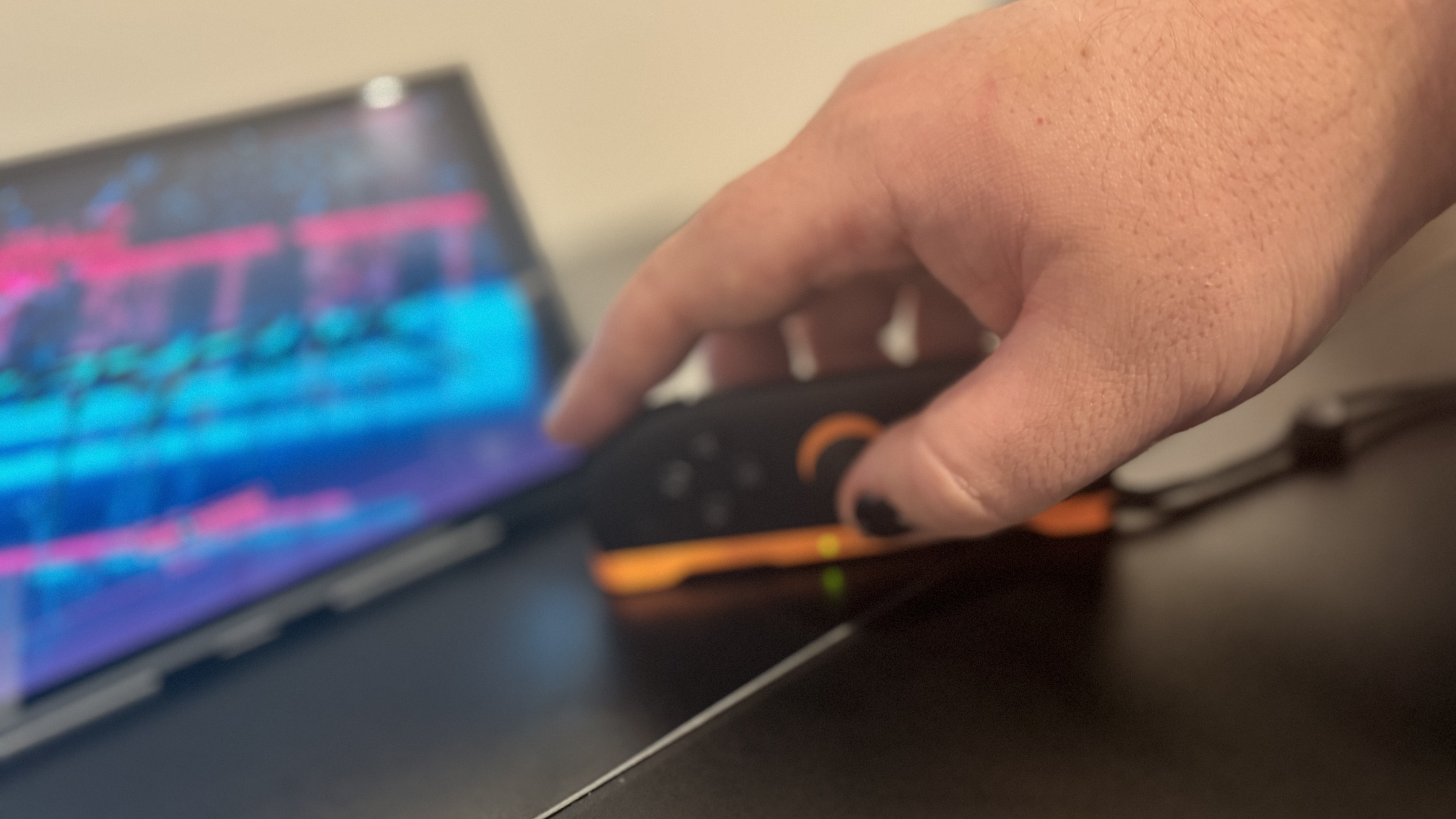 A picture of a Nintendo Switch 2, in mouse mode, with Cyberpunk 2077 in the background