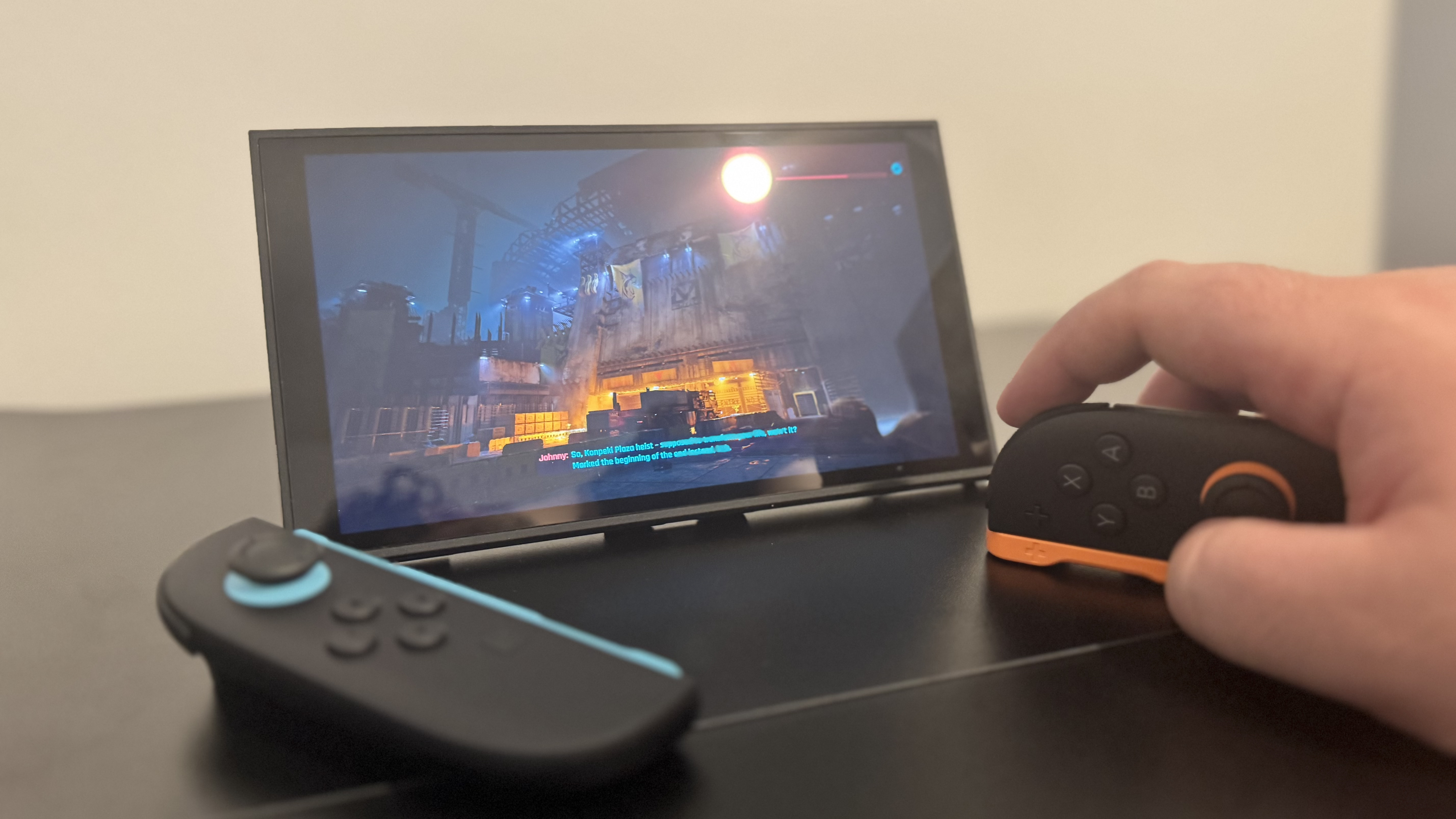 A picture of a Nintendo Switch 2, in mouse mode, with Cyberpunk 2077 in the background