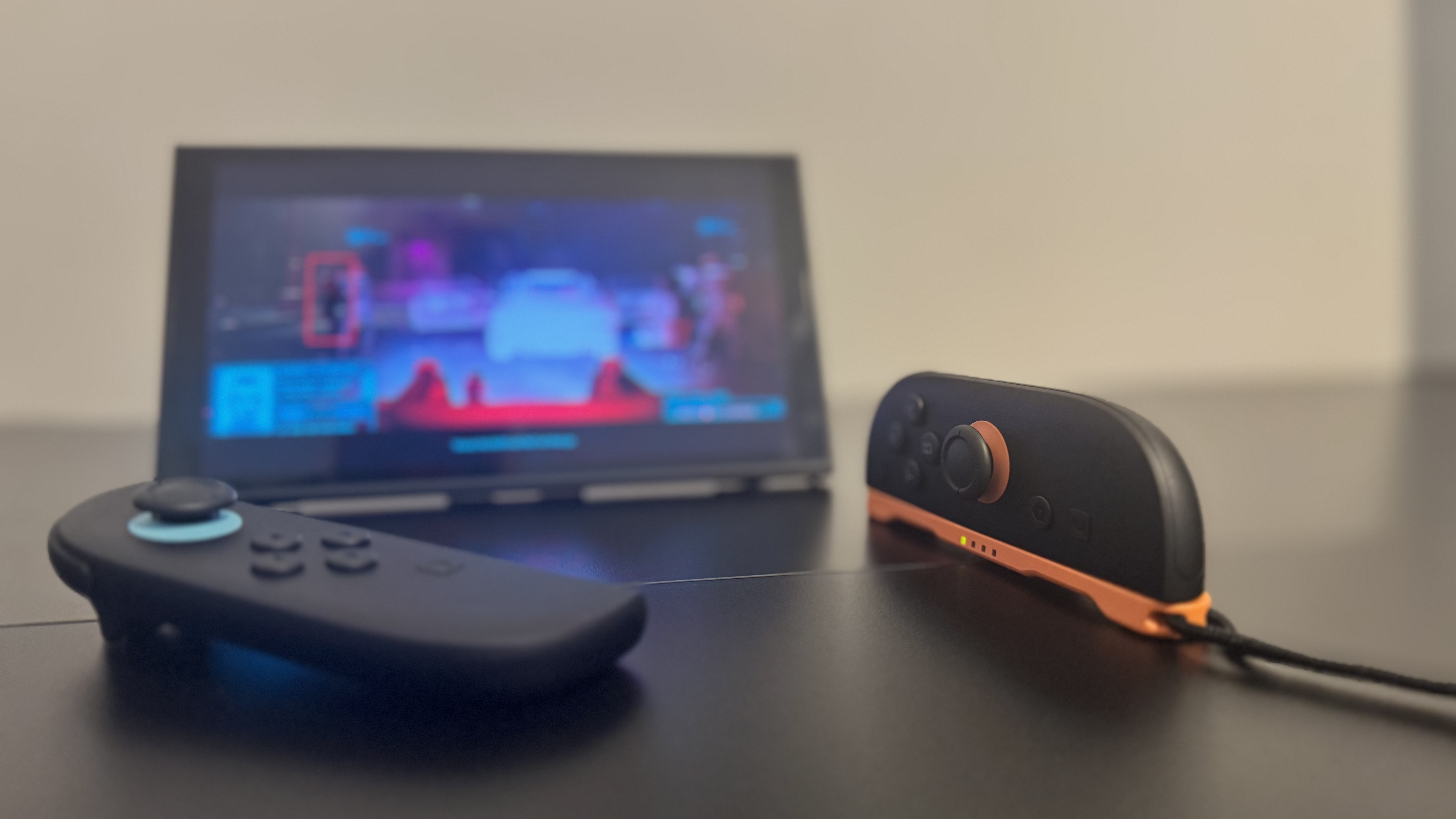 A picture of a Nintendo Switch 2, in mouse mode, with Cyberpunk 2077 in the background
