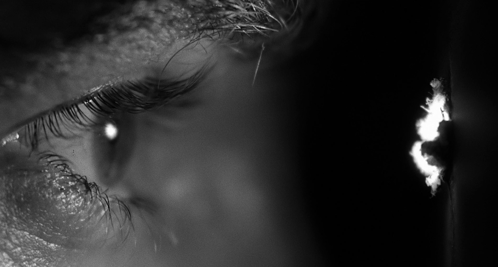 close-up of an eye looking through a peephole in Psycho