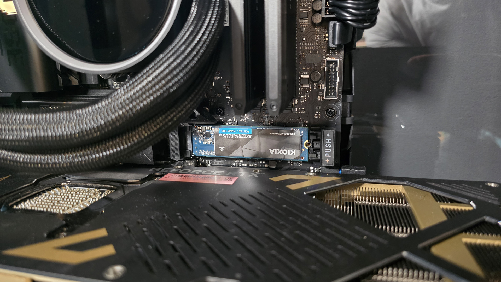 The Kioxia Exceria Plus G4 on a desk, ready to be installed inside a gaming PC.