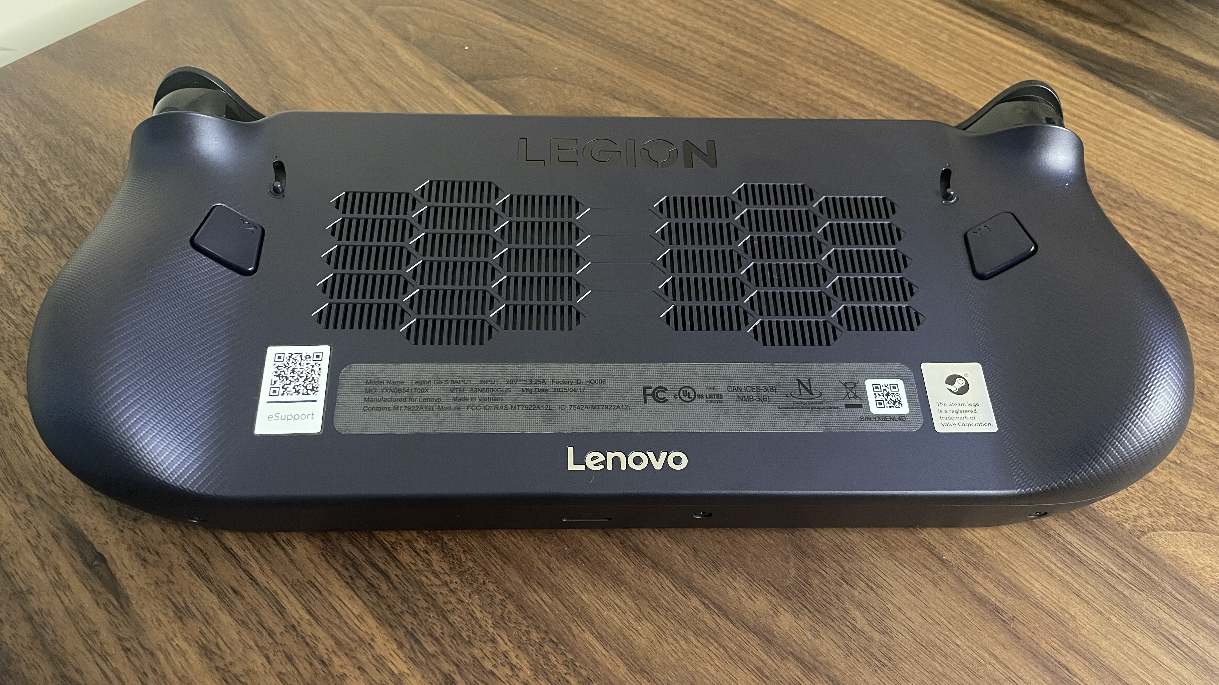 A Lenovo Legion Go S handheld with SteamOS in Nebula Nocturne colour scheme - upside down view