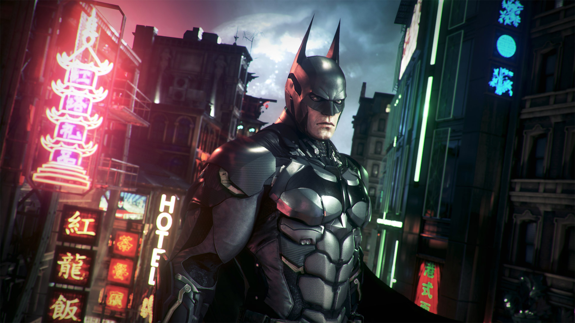 A screenshot from Batman Arkham Knight featuring Batman looking moody in front of a modern cityscape that looks like Tokyo, Japan A screenshot from Batman Arkham Knight featuring Batman looking moody in front of a modern cityscape that looks like Tokyo, Japan