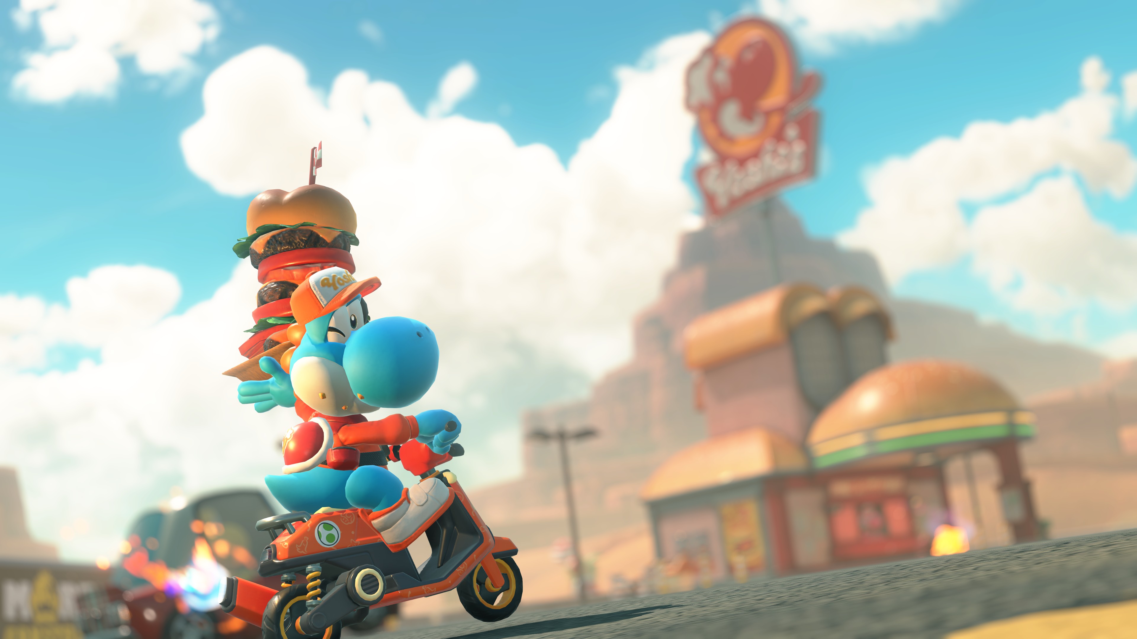 A blue Yoshi holds up a stacked burger outside a Yoshi’s drive-in in Mario Kart World A blue Yoshi holds up a stacked burger outside a Yoshi’s drive-in in Mario Kart World