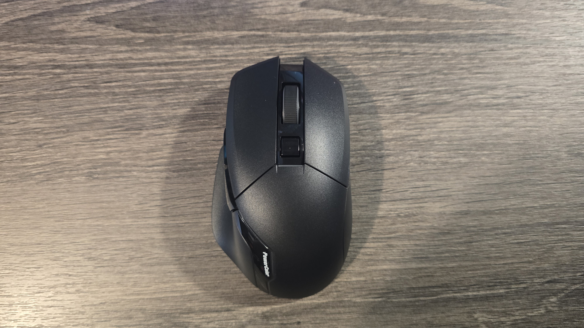 Powercolor Alphyn AM10 Wireless Gaming Mouse with RGB enabled on a desk.