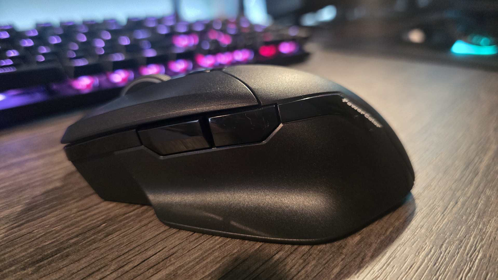 Powercolor Alphyn AM10 Wireless Gaming Mouse with RGB enabled on a desk.