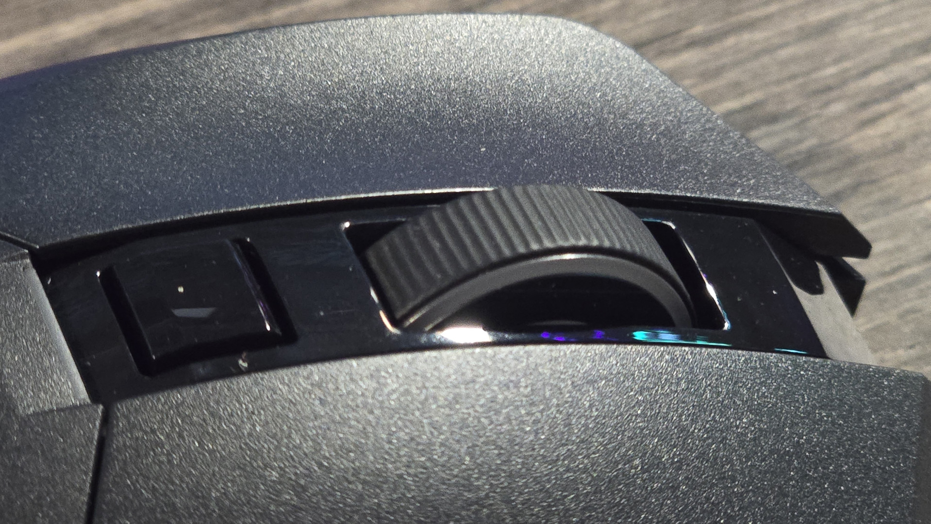 Powercolor Alphyn AM10 Wireless Gaming Mouse with RGB enabled on a desk.