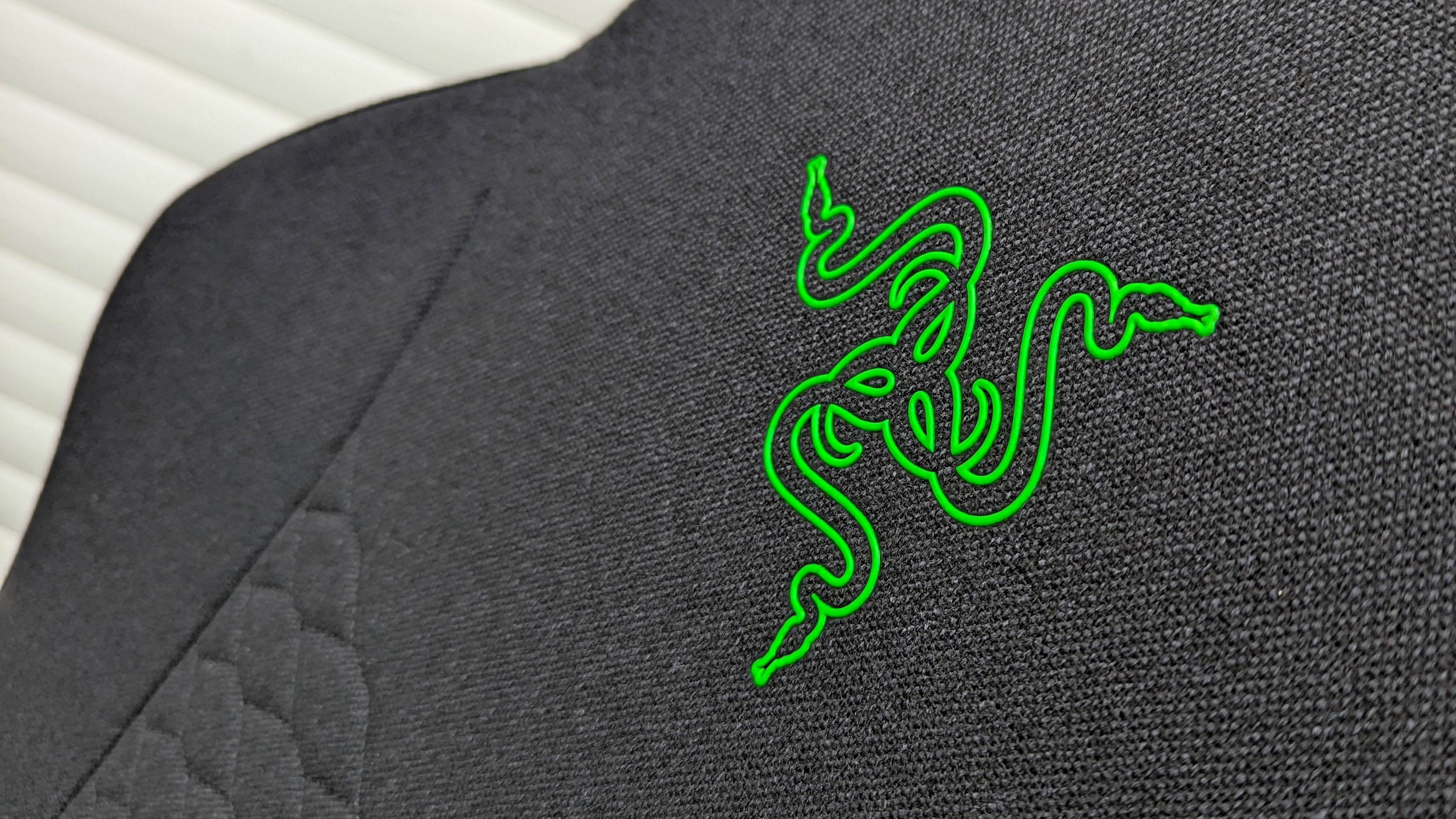 Razer Iskur V2 X gaming chair set-up outside with some Razer branded gloves!