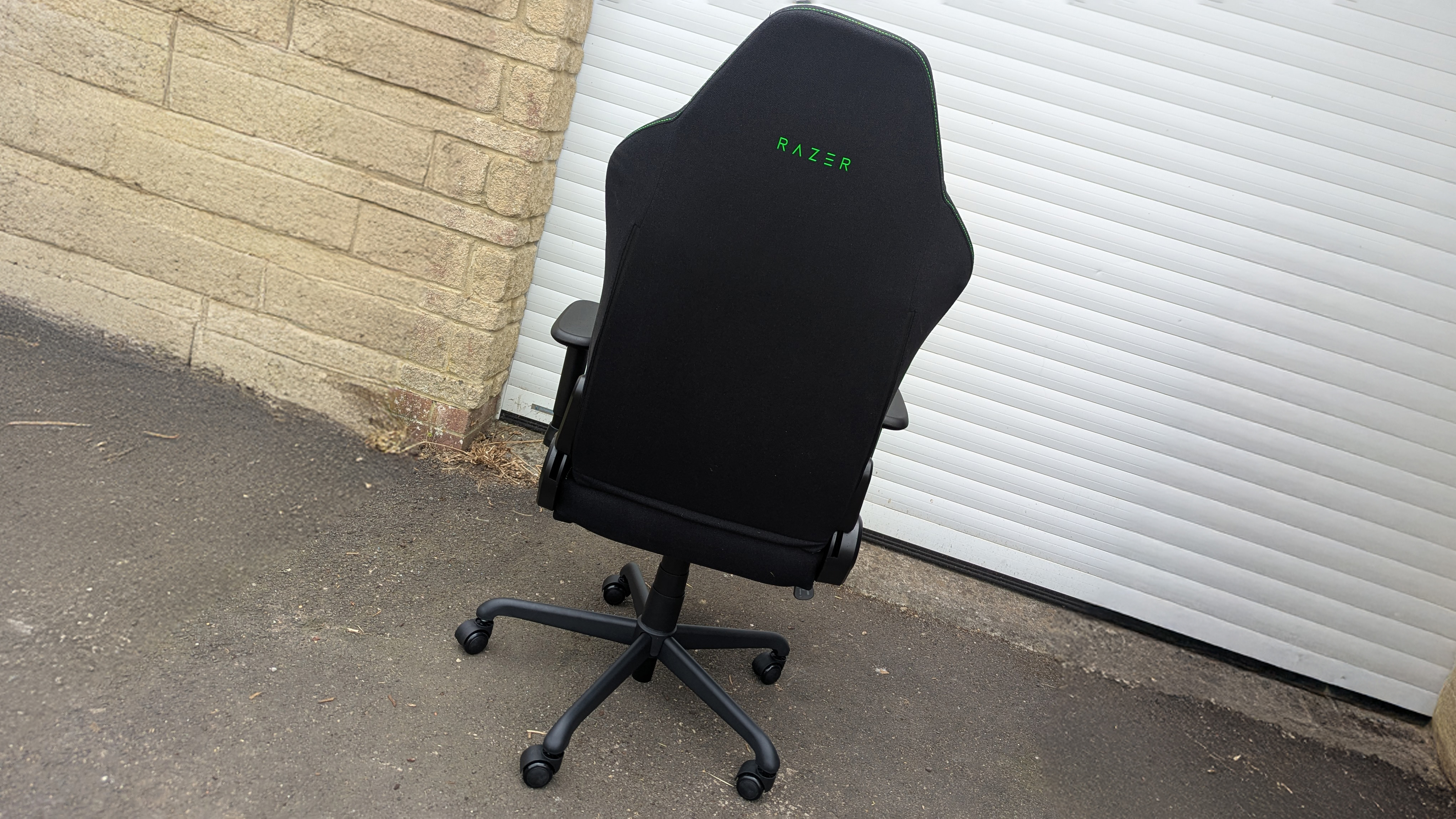Razer Iskur V2 X gaming chair set-up outside with some Razer branded gloves!
