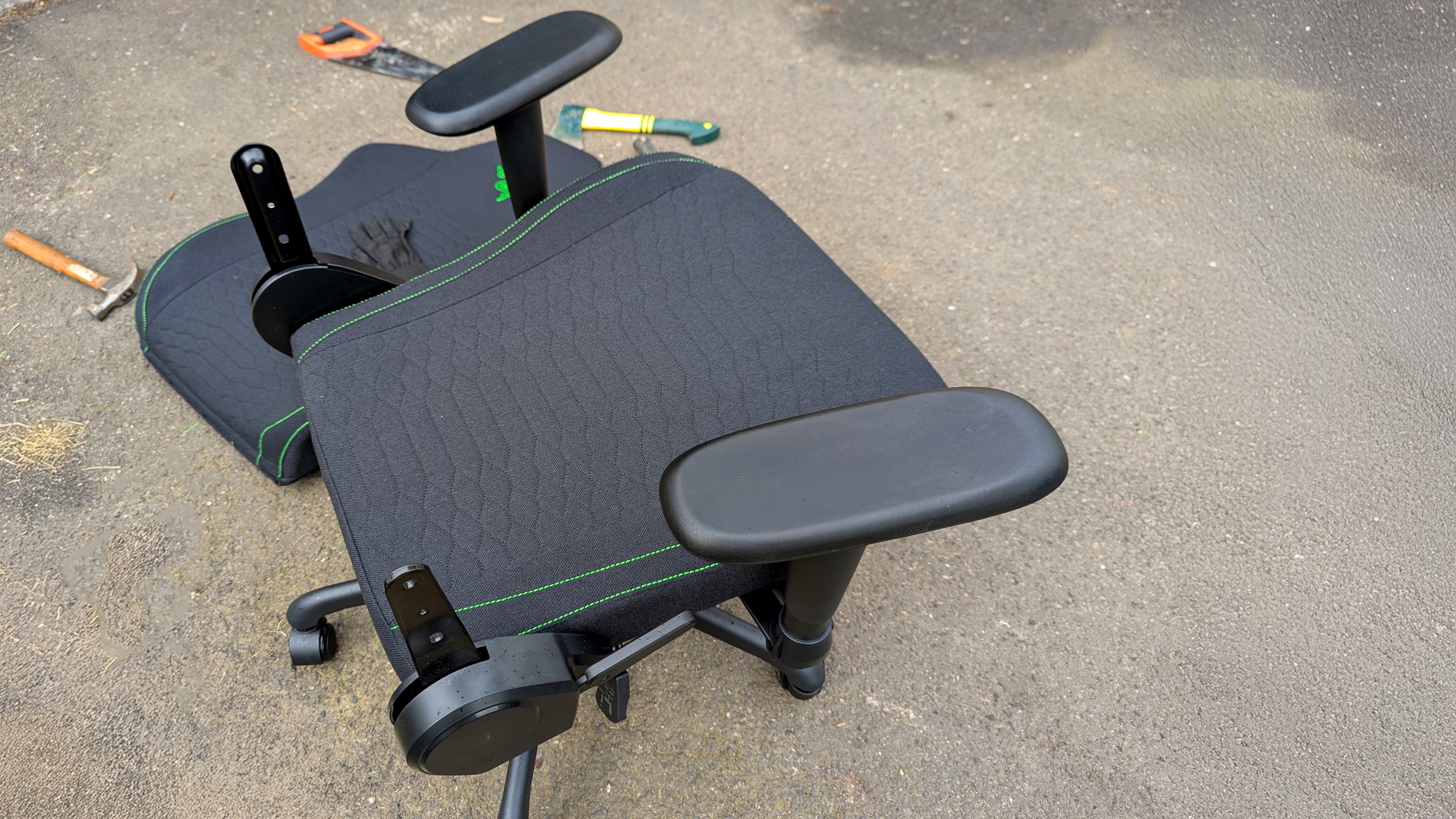 Razer Iskur V2 X gaming chair set-up outside with some Razer branded gloves!