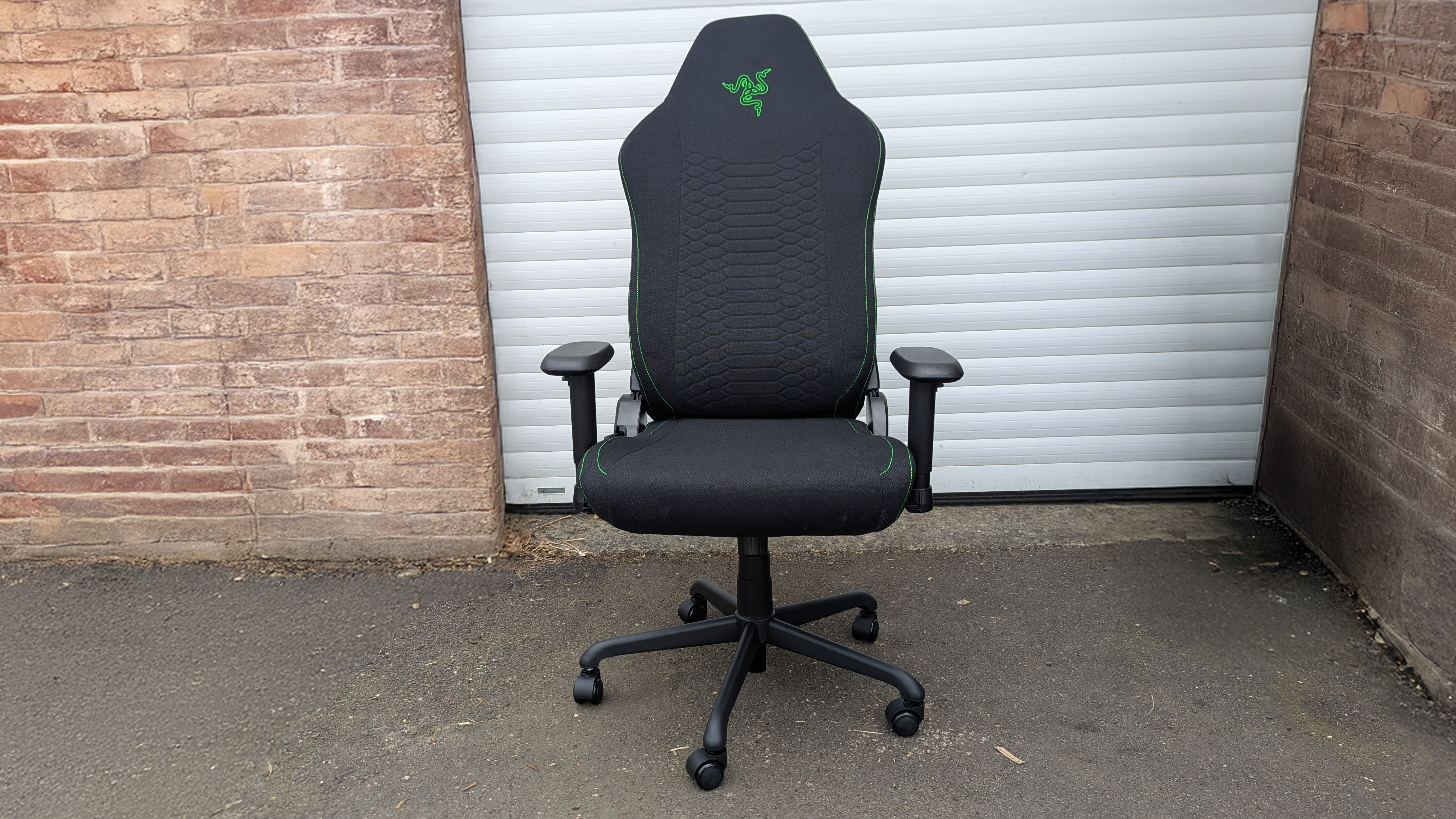 Razer Iskur V2 X gaming chair set-up outside with some Razer branded gloves!