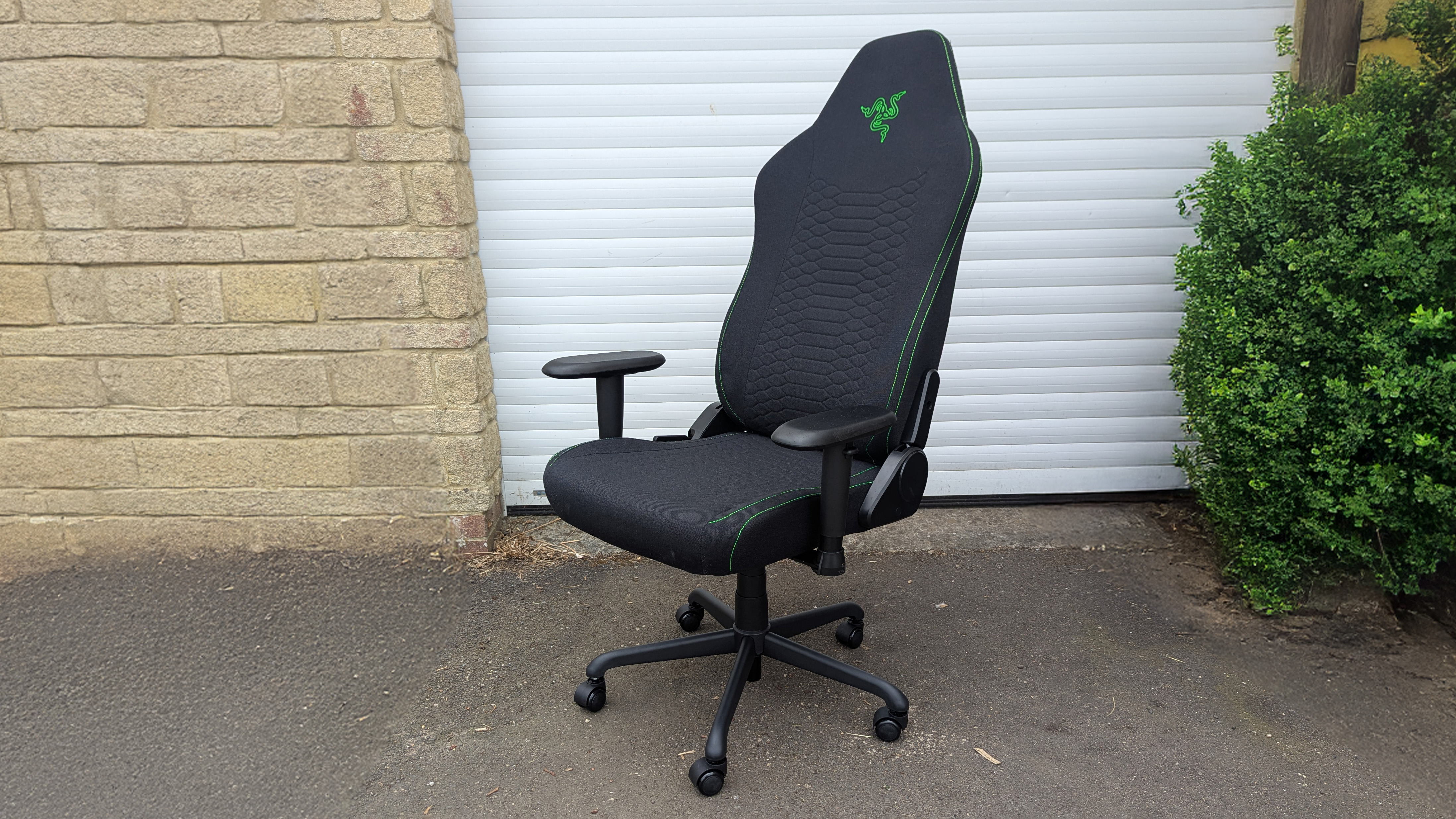 Razer Iskur V2 X gaming chair set-up outside with some Razer branded gloves!