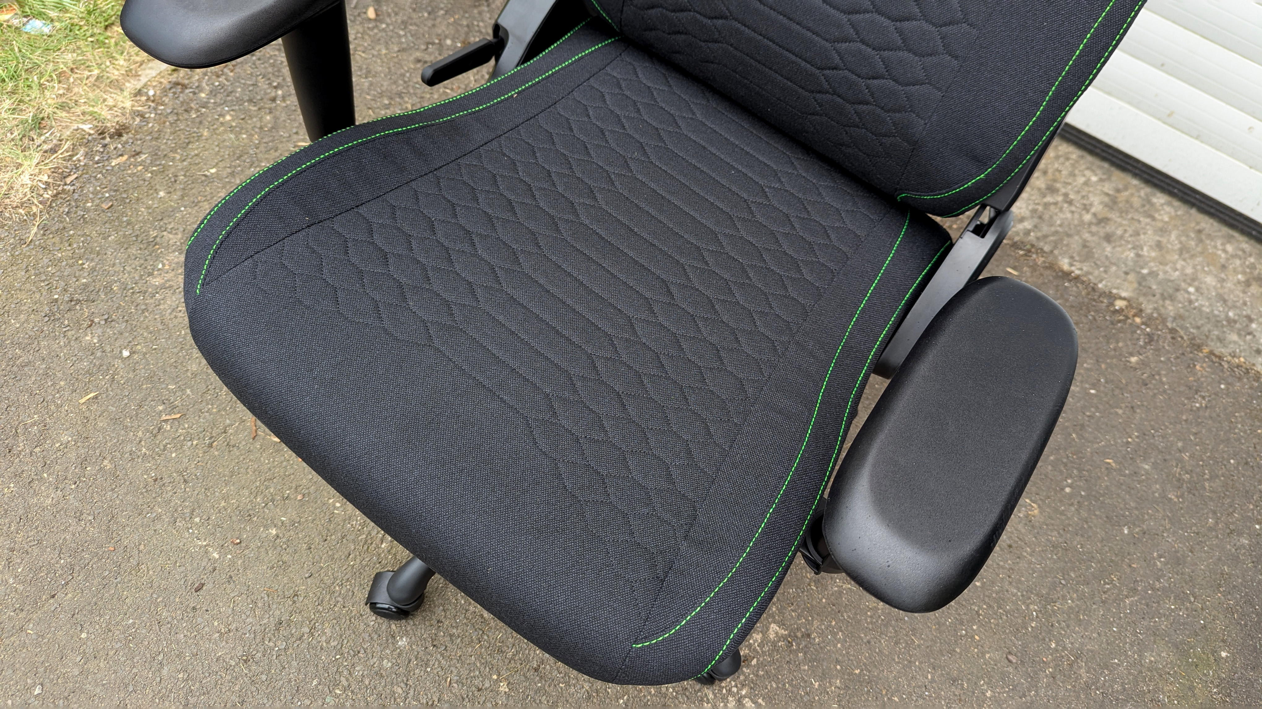 Razer Iskur V2 X gaming chair set-up outside with some Razer branded gloves!