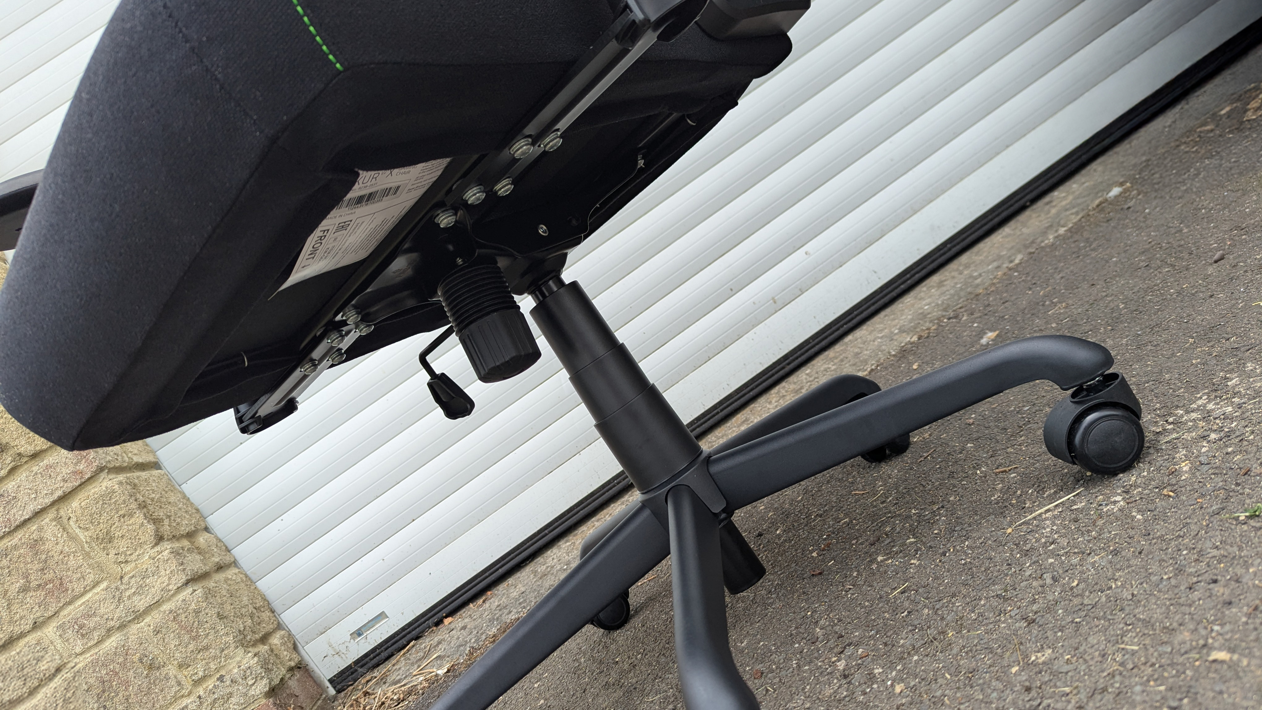 Razer Iskur V2 X gaming chair set-up outside with some Razer branded gloves!
