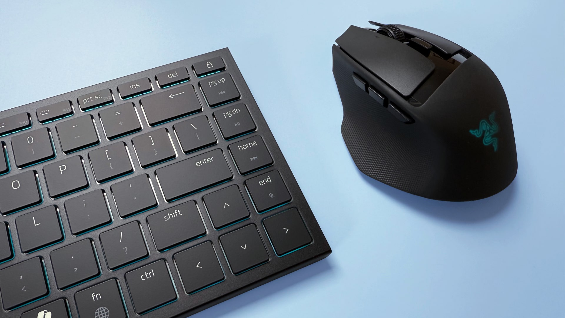 A Razer Basilisk Mobile gaming mouse and Razer Joro portable gaming keyboard on a blue background.