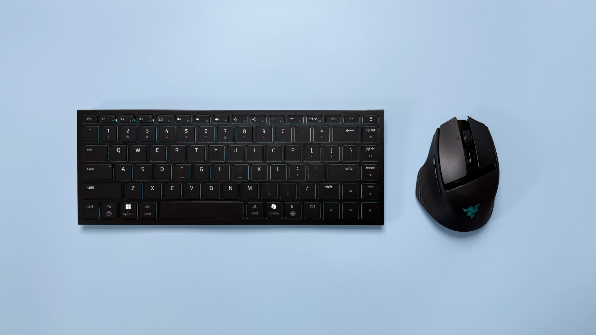A Razer Basilisk Mobile gaming mouse and Razer Joro portable gaming keyboard on a blue background.