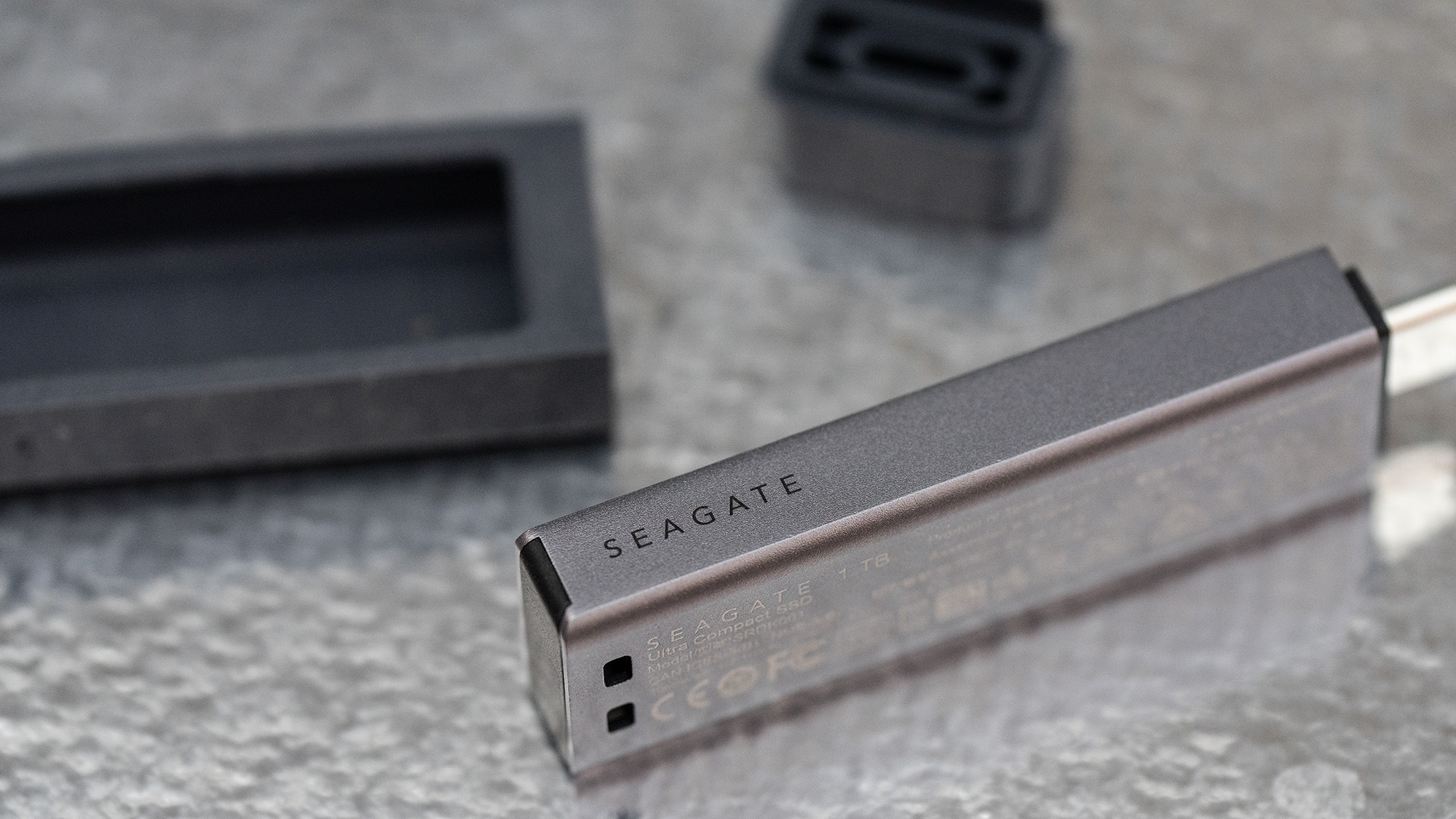 Seagate Ultra Compact SSD on a glass background.