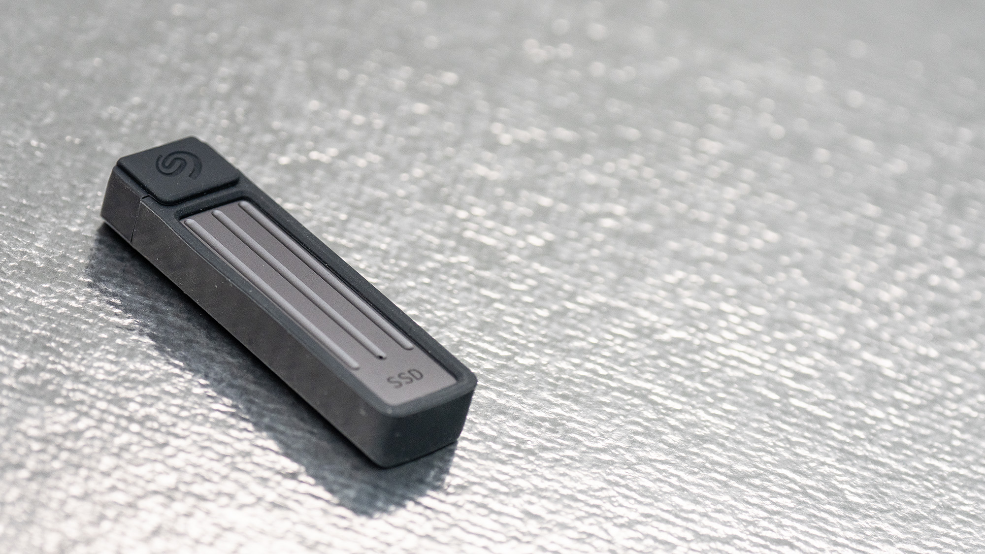 Seagate Ultra Compact SSD on a glass background.