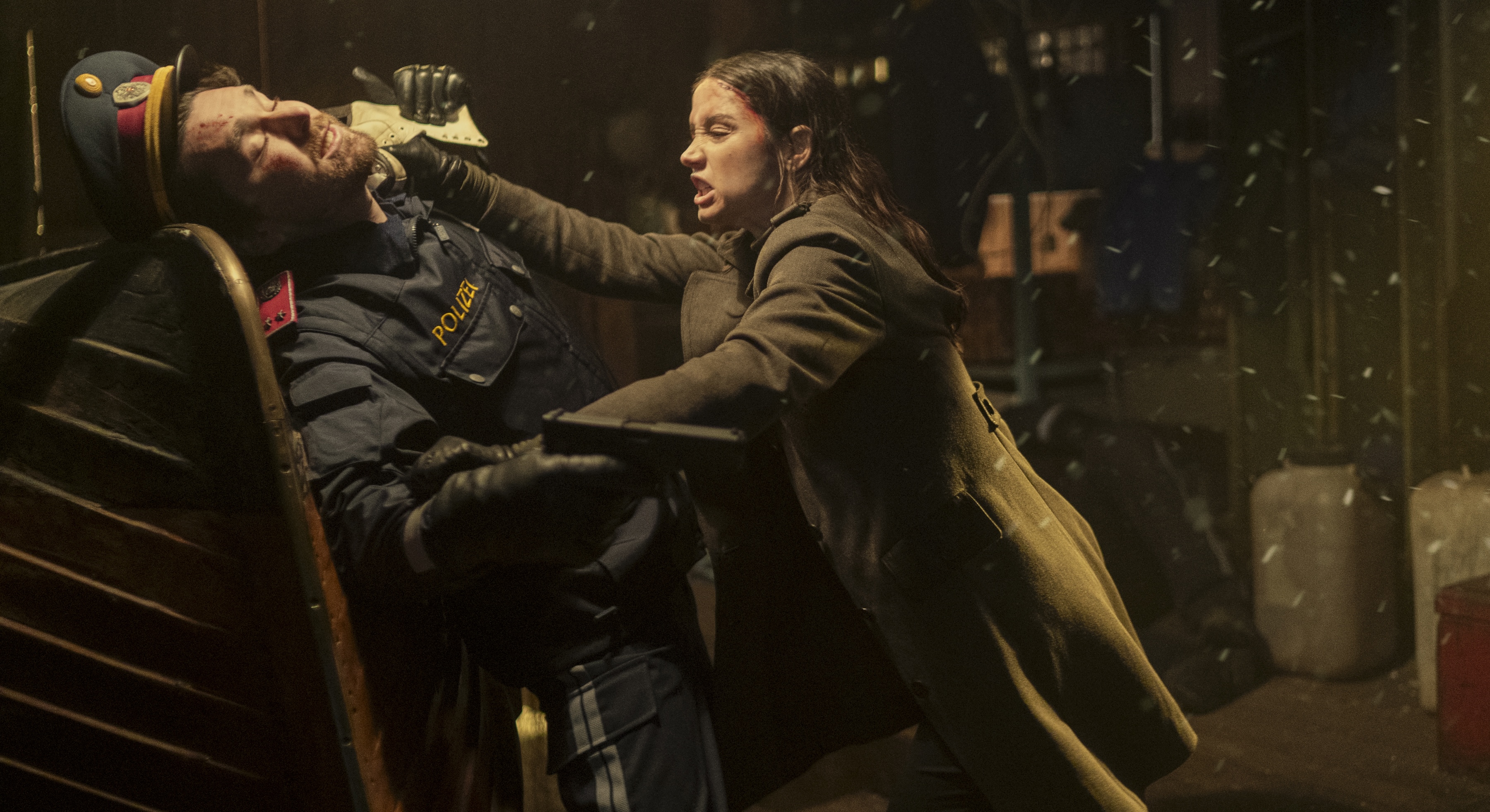 Eve (Ana de Armas) strangles a gun-wielding man in a retro military hat and trenchcoat in the John Wick spin-off Ballerina Eve (Ana de Armas) strangles a gun-wielding man in a retro military hat and trenchcoat in the John Wick spin-off Ballerina