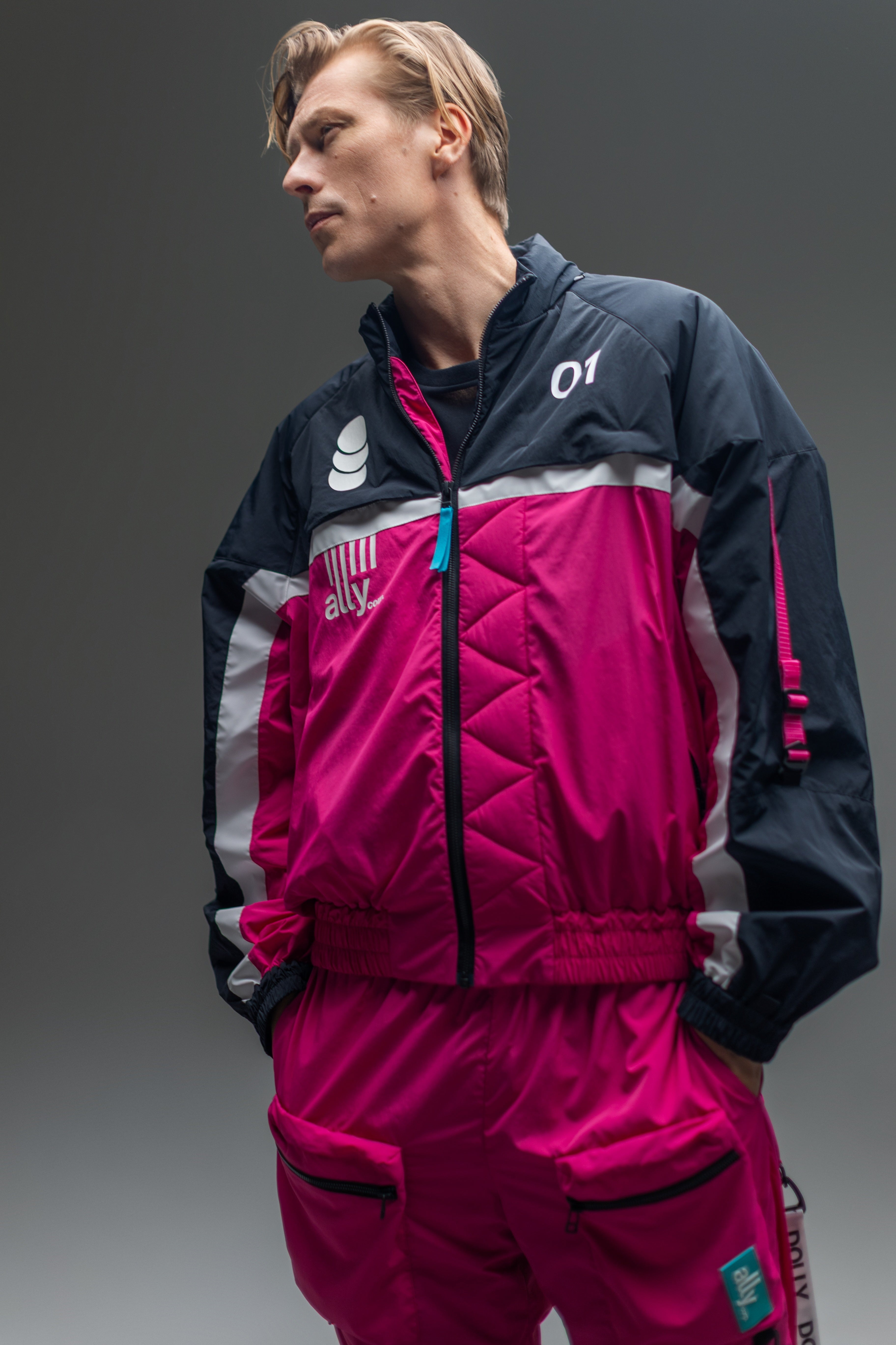 A male model wearing the full Alters tracksuit.