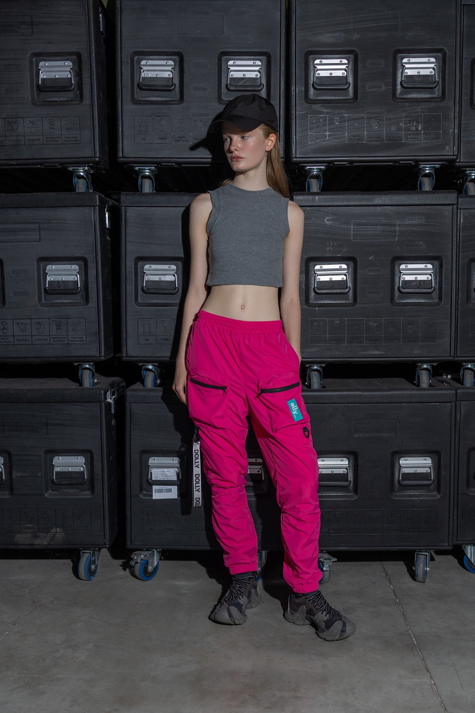 A female model wearing the Alters tracksuit bottoms.