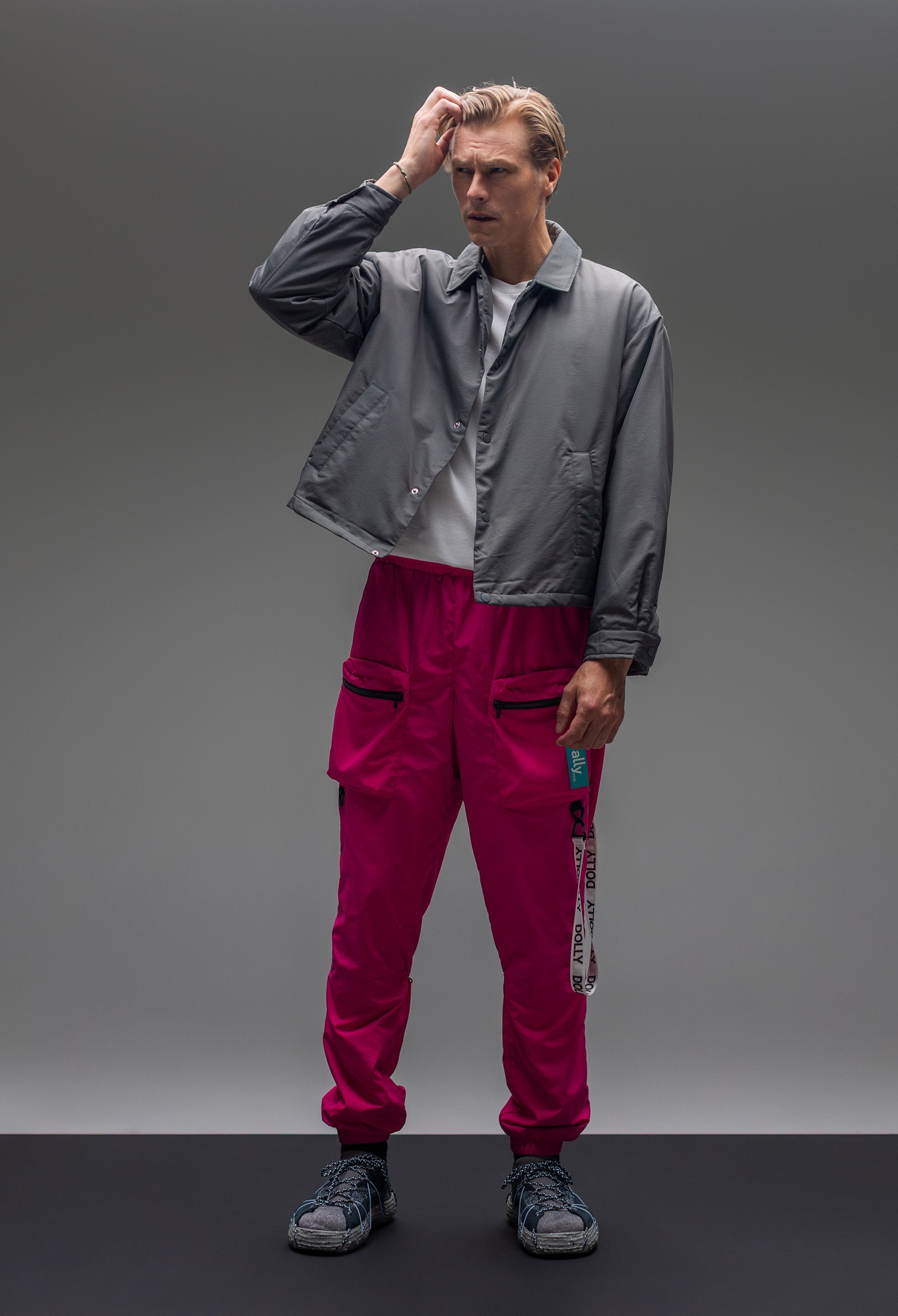 A male model wearing the Alters tracksuit bottoms.