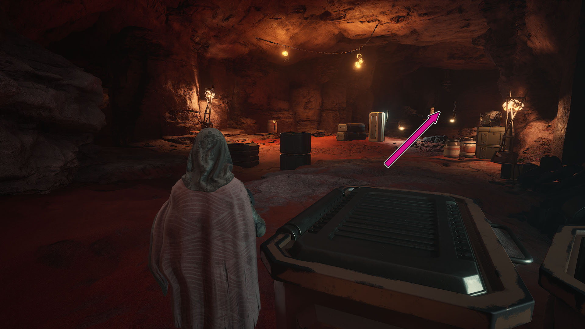 A Dune: Awakening screenshot showing a character inside a large room and a pink arrow pointing to the corridor players must follow to find the third Trial.